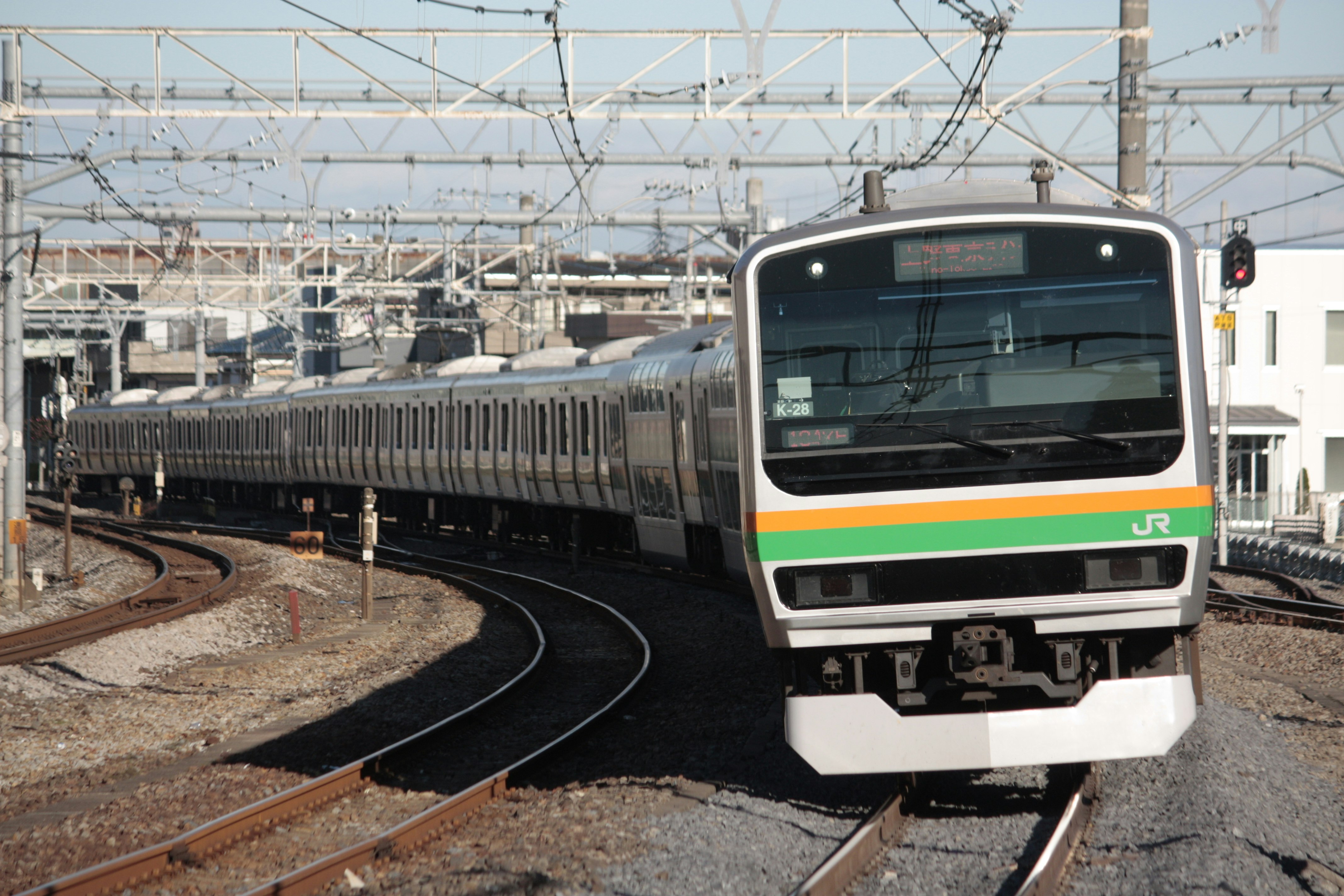 front view of a JR limited express train running on a curving railway track