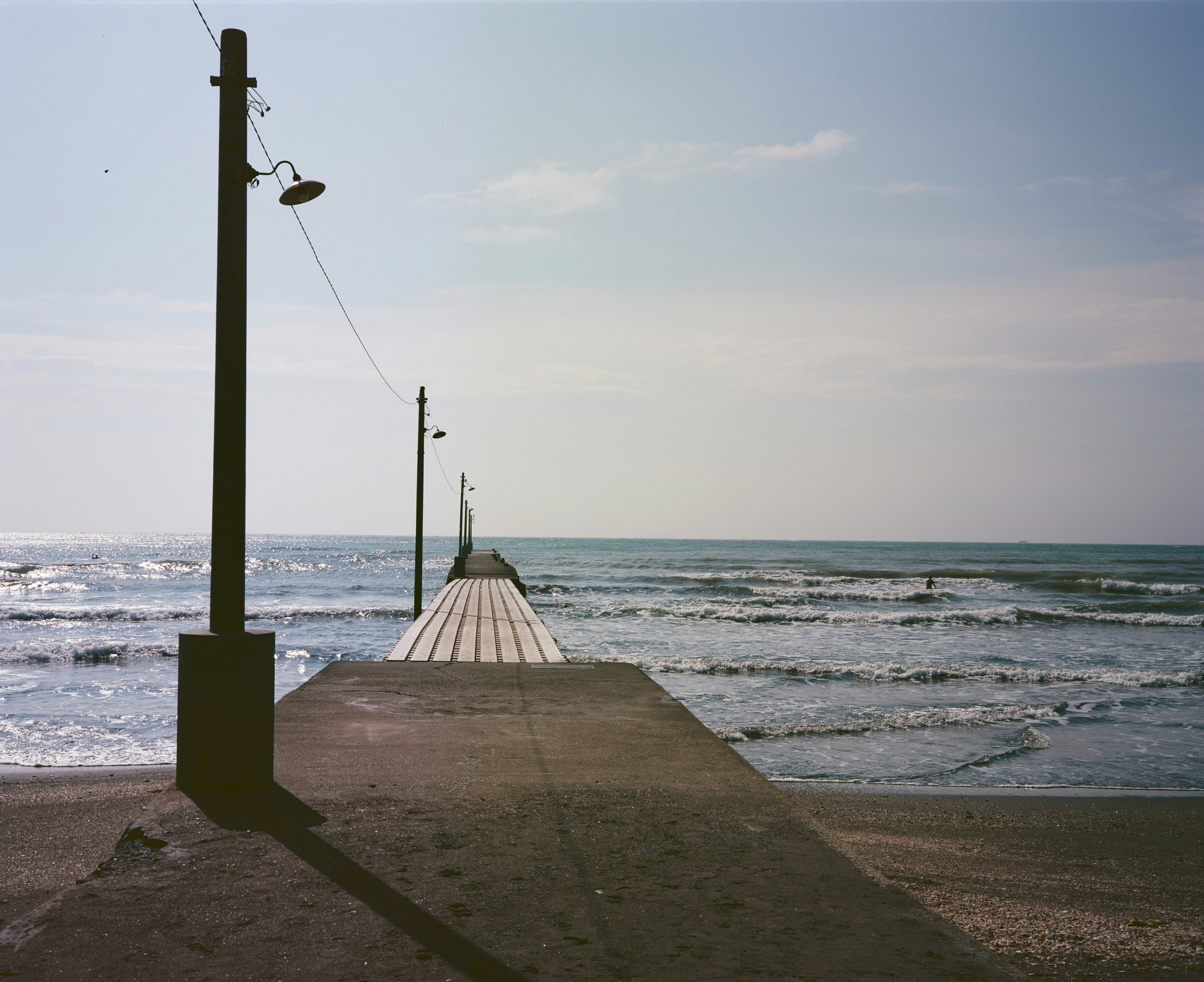 Seaside breakwater and shoreline waves at dusk
