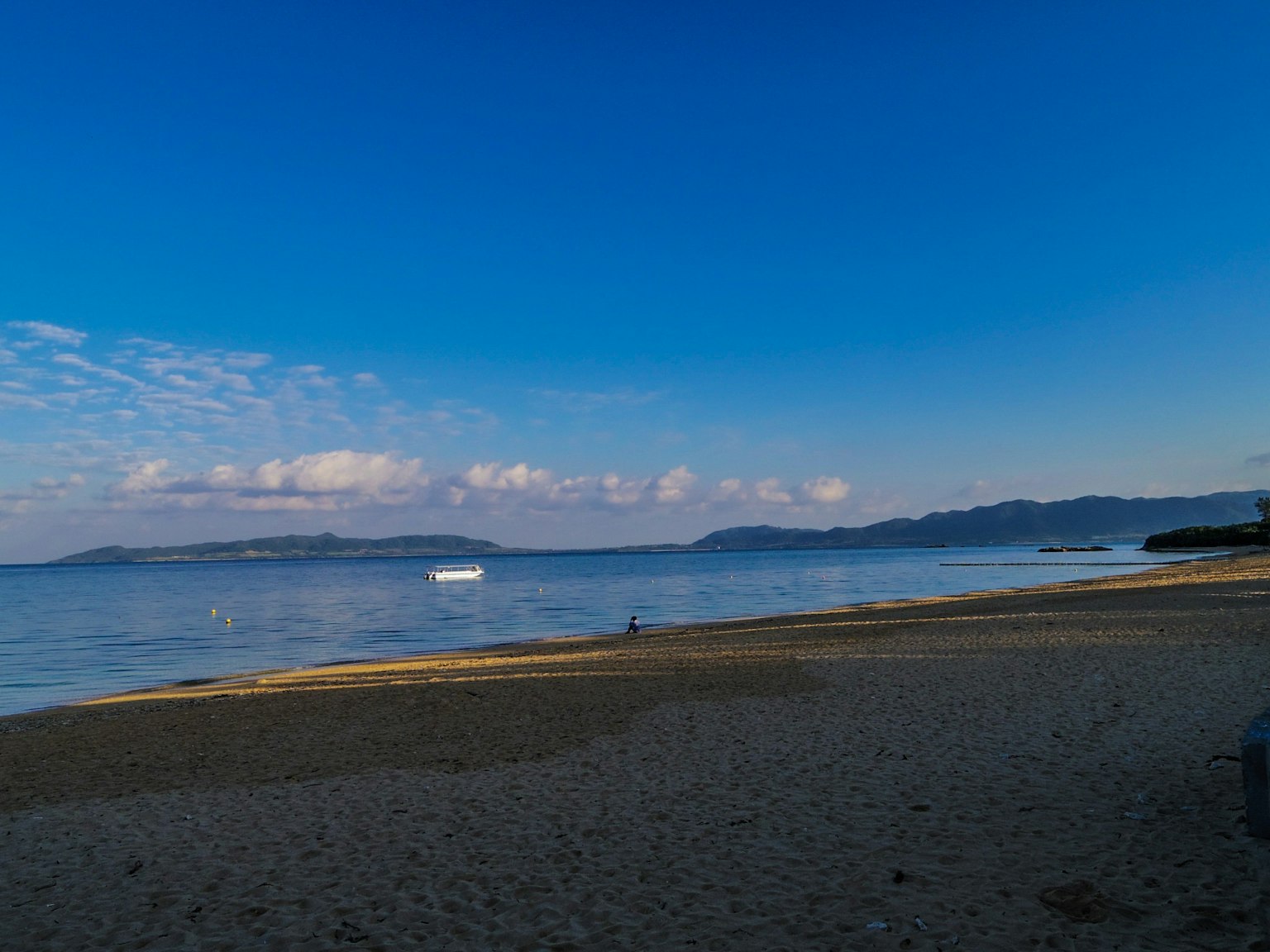 Scenic beach view with blue sky and calm sea