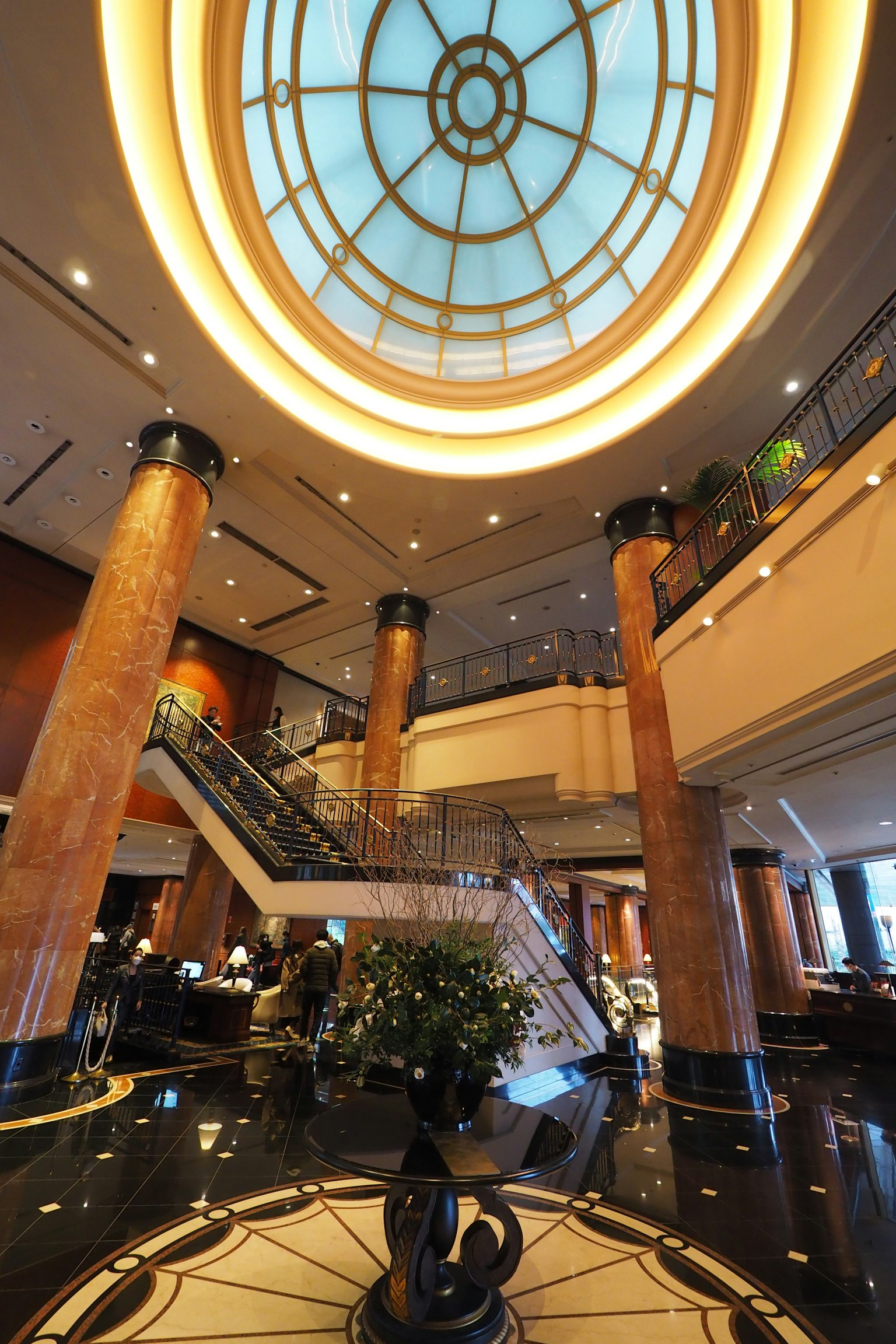 Luxurious lobby featuring a circular ceiling and marble columns