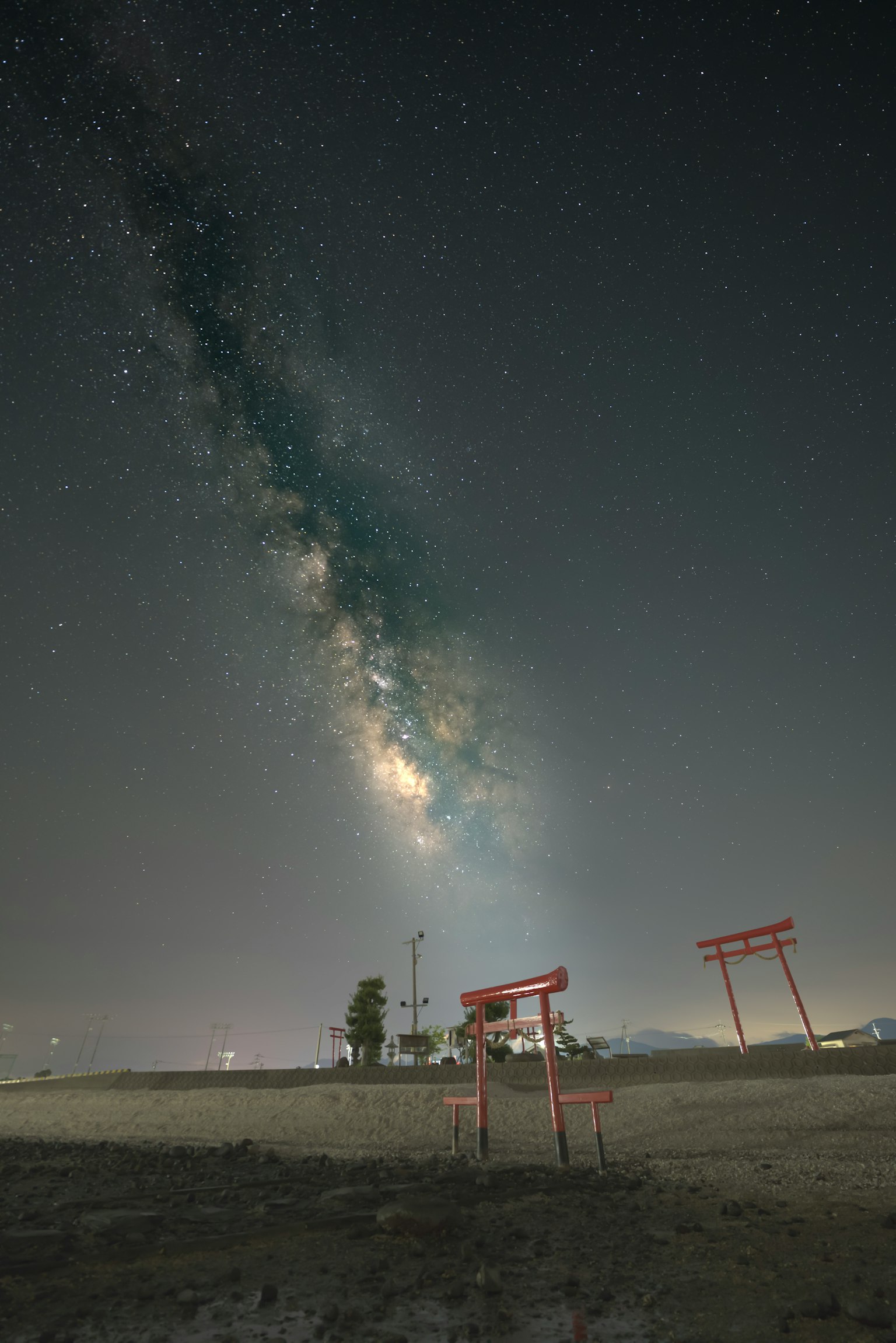 Puertas torii rojas bajo un cielo estrellado con la Vía Láctea