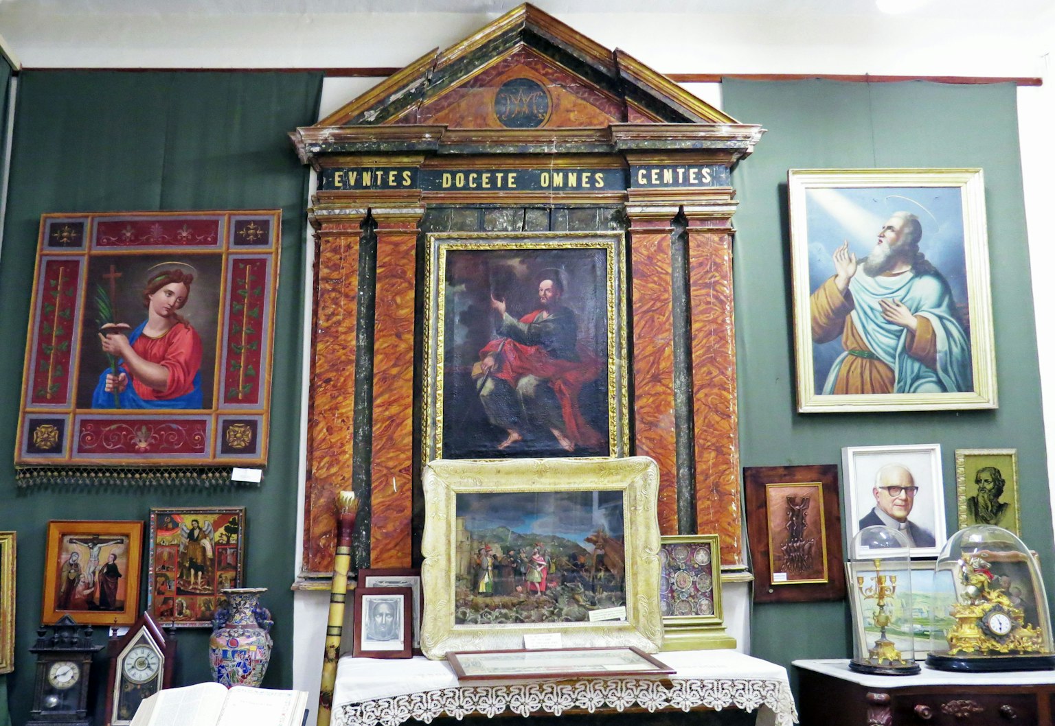 Parete decorata con dipinti colorati e cornici ornate in un ambiente antico
