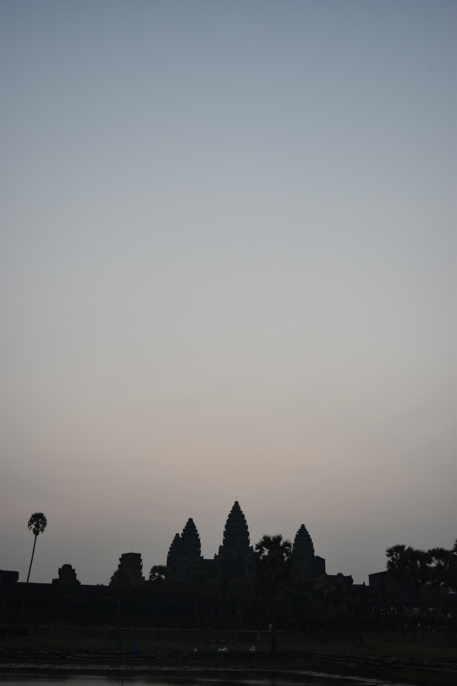 Silhouette of Angkor Wat against a twilight sky