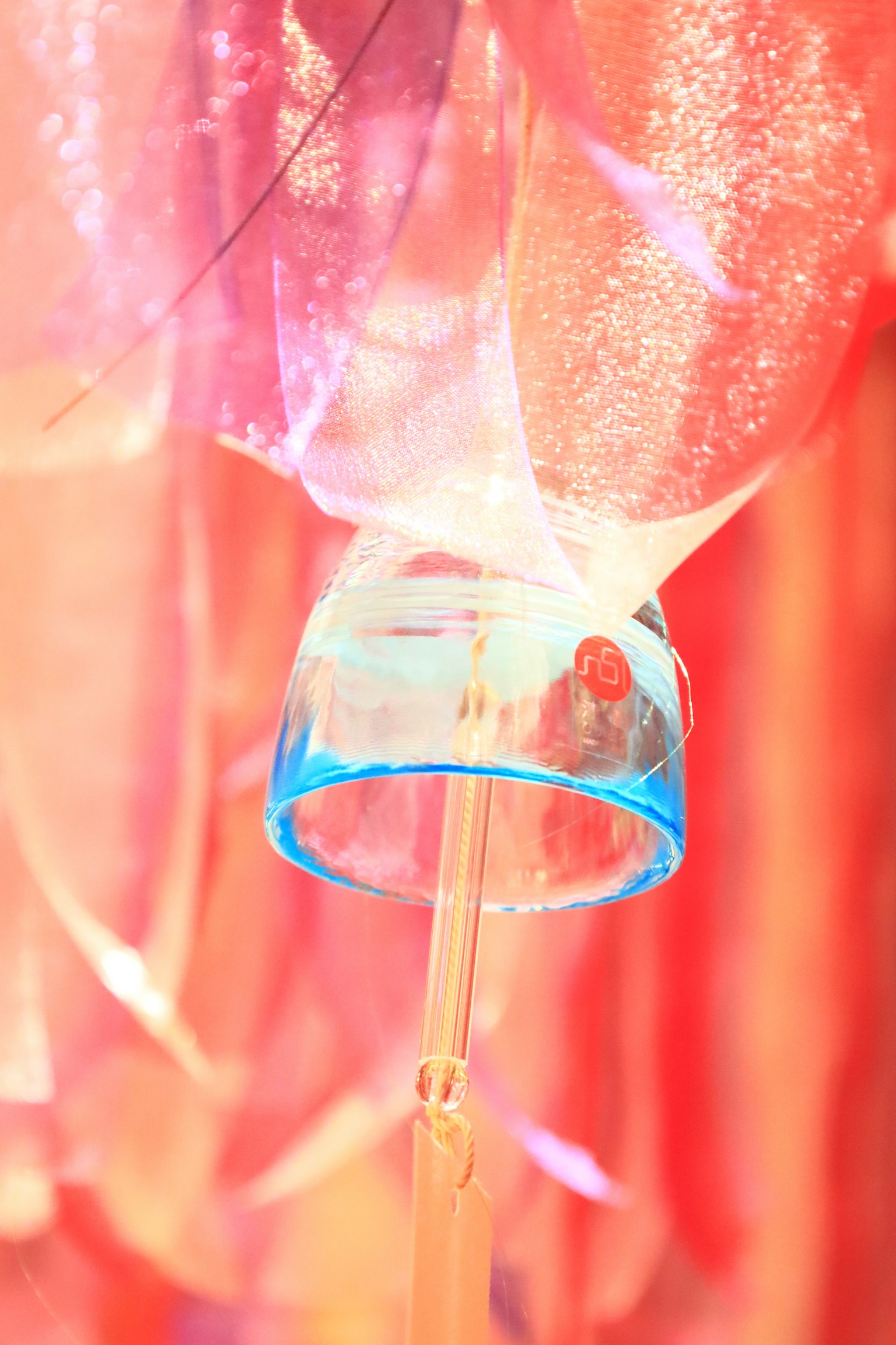 Blue cup with colorful fabric layers in an artistic display