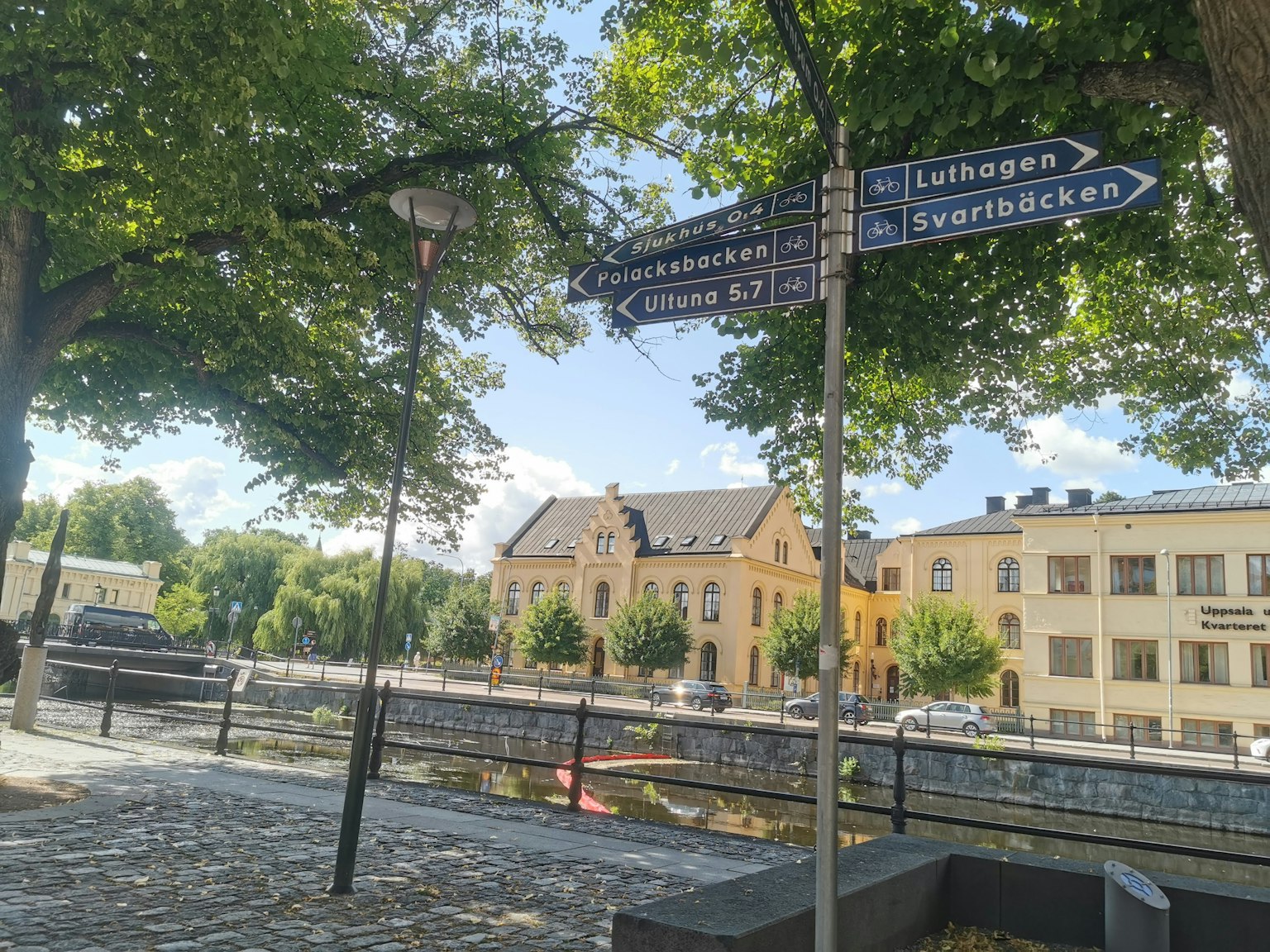 Straßenschilder und Flussblick an einem sonnigen Tag