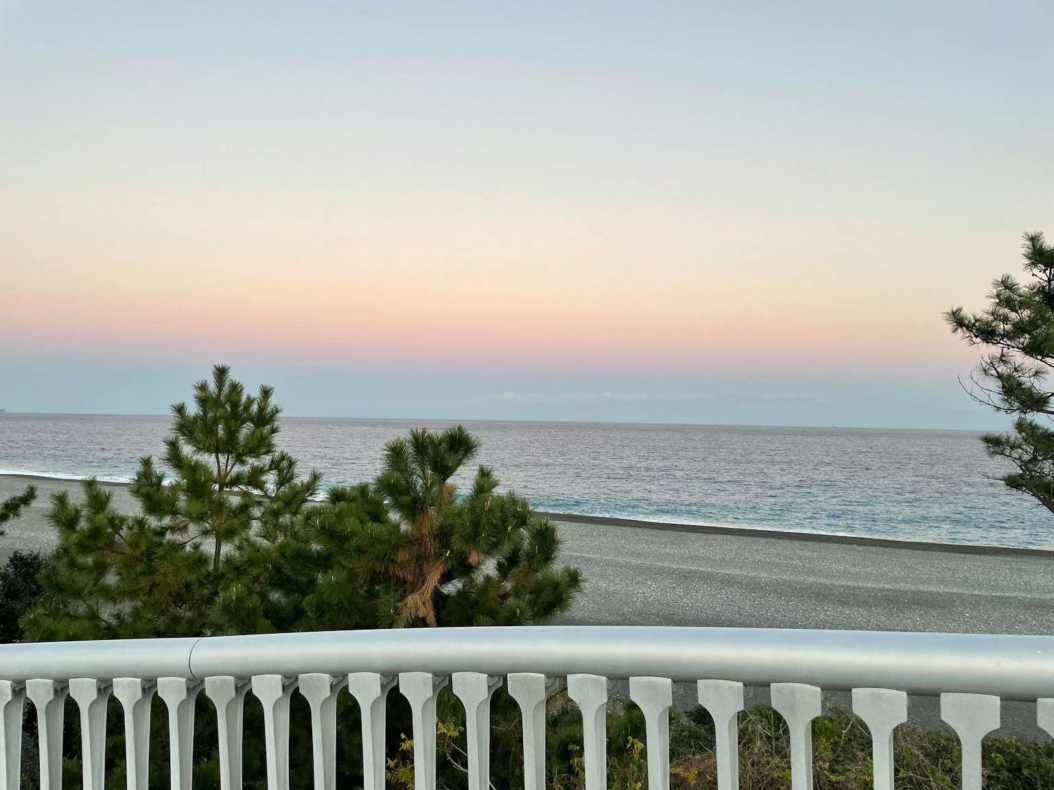 Scenic view of the sea with a pastel gradient sky