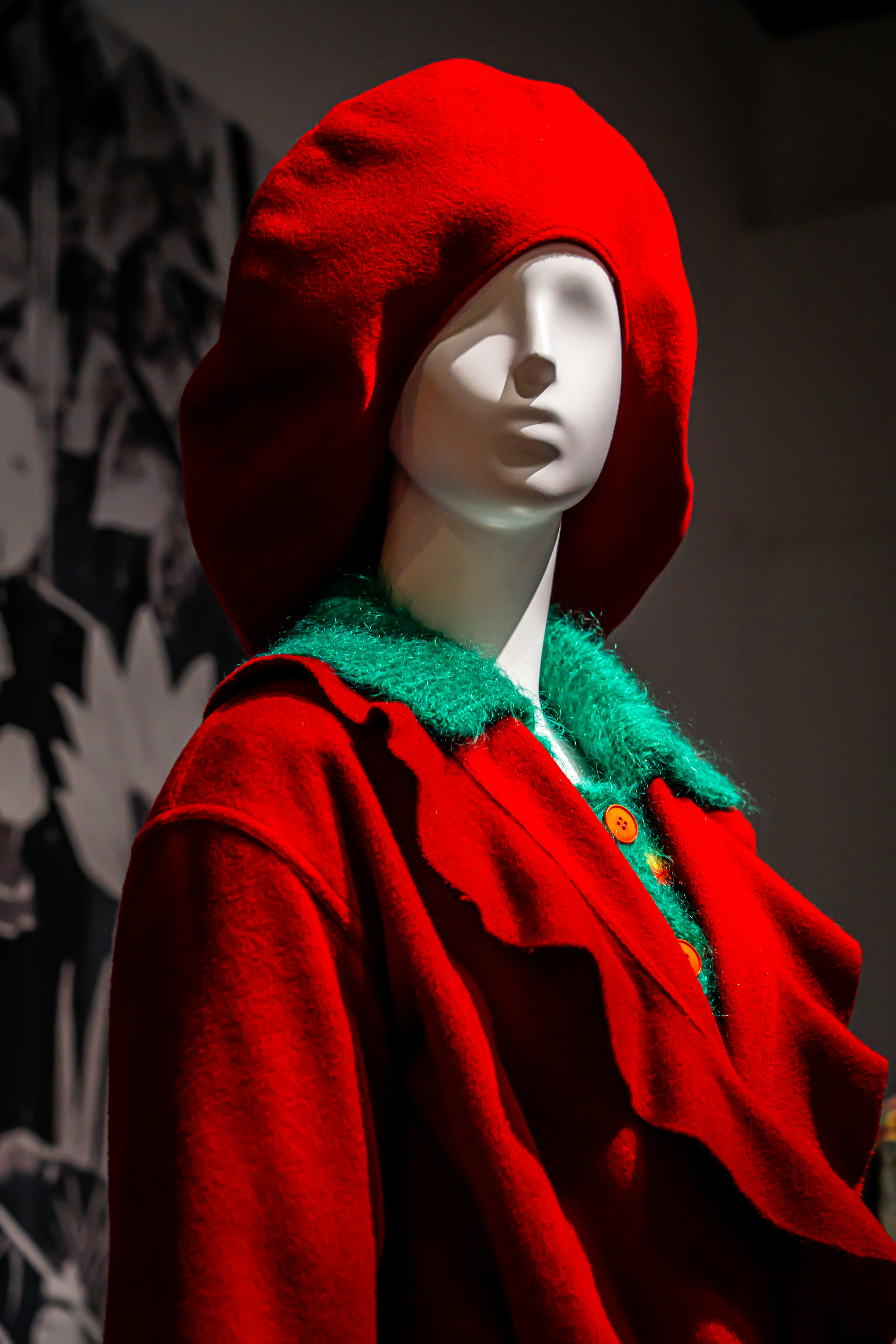 Red-hood mannequin with a green fur-collar outfit