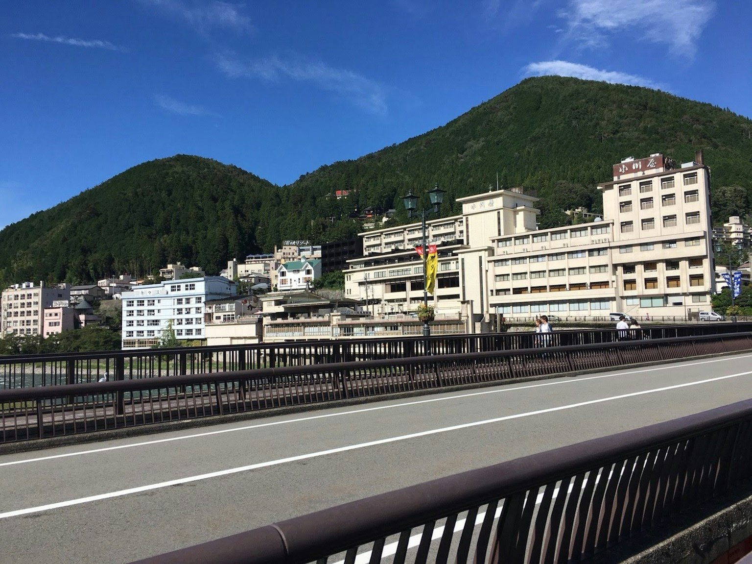 Scenic view of a bridge with buildings and mountains