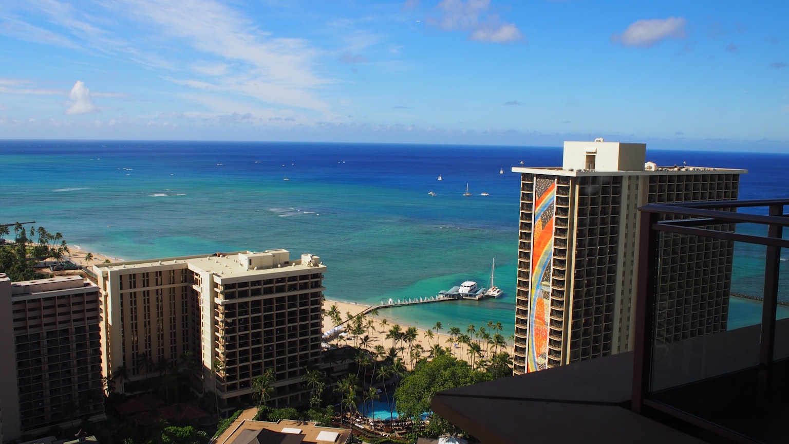 View of Honolulu beach and ocean with skyscrapers and blue sky