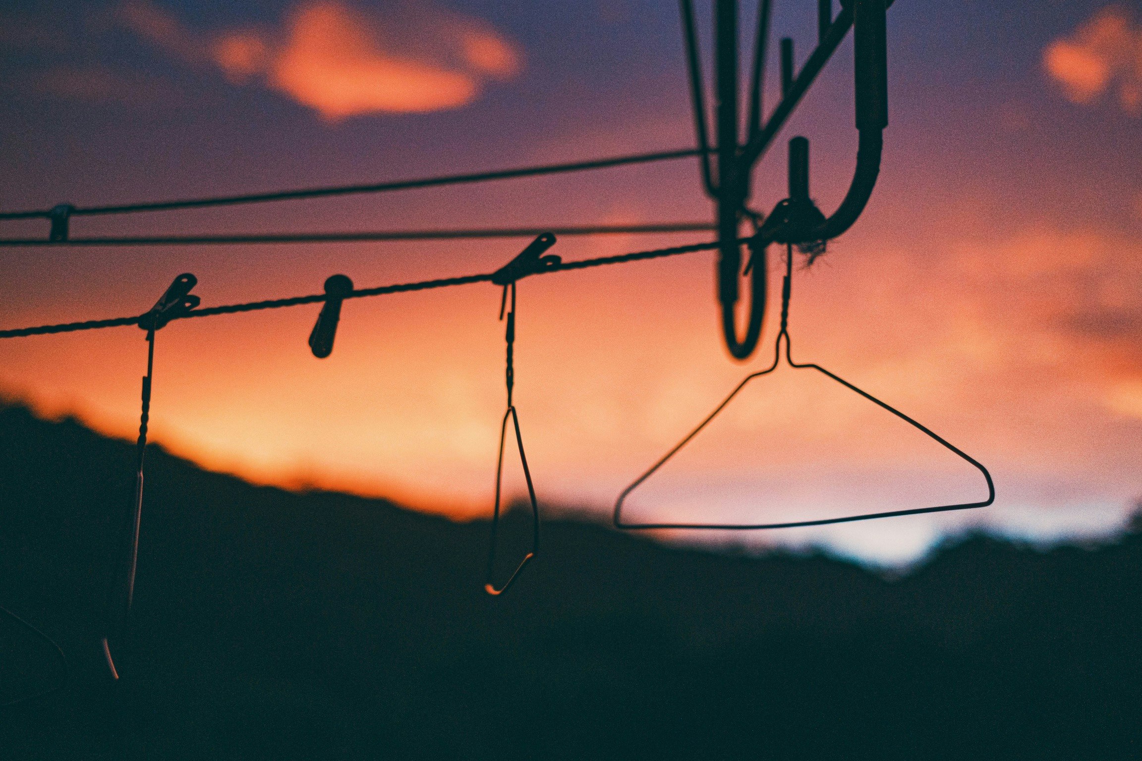 hangers and clothesline under a sunset sky