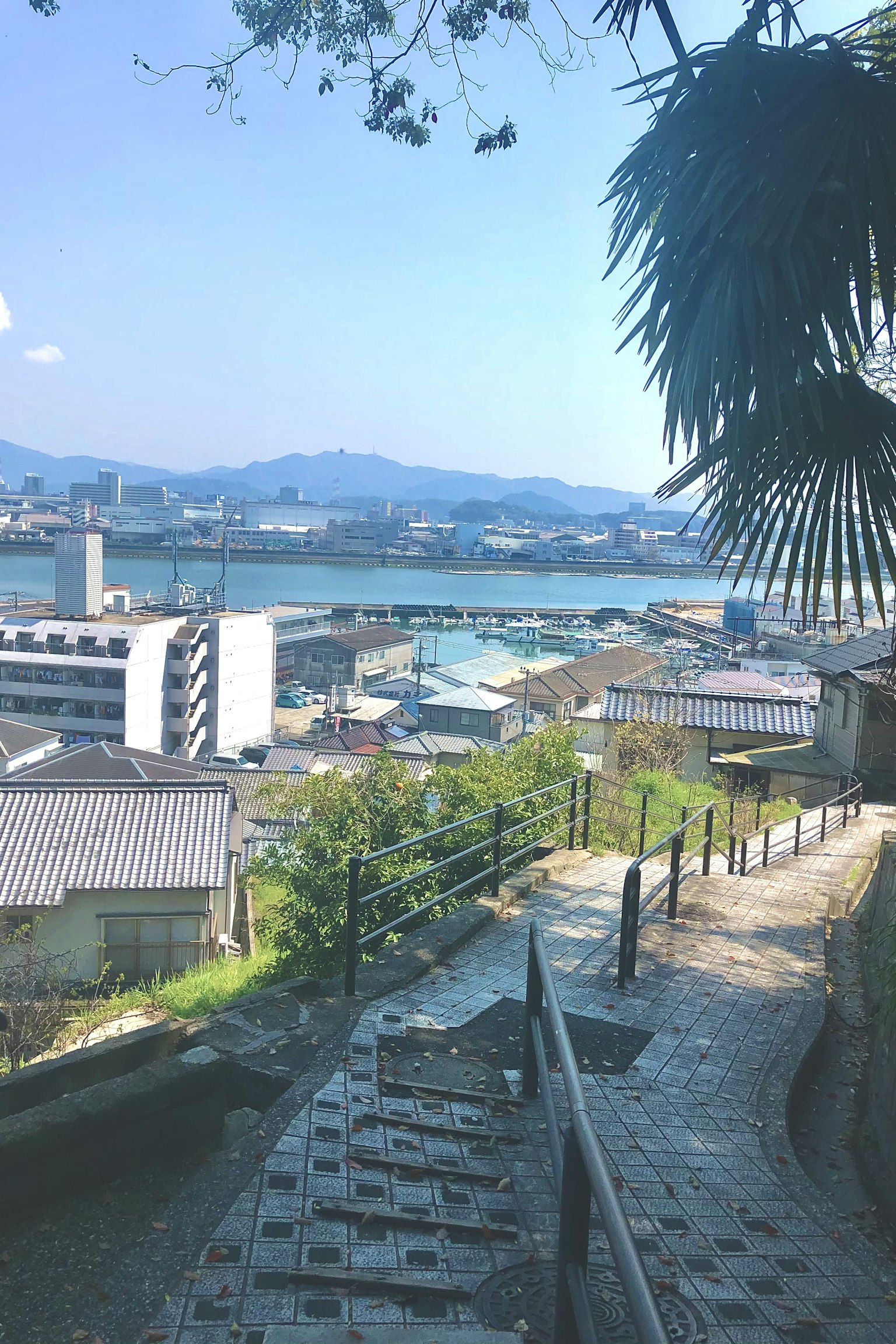 Scenic view of a coastal town with mountains in the background