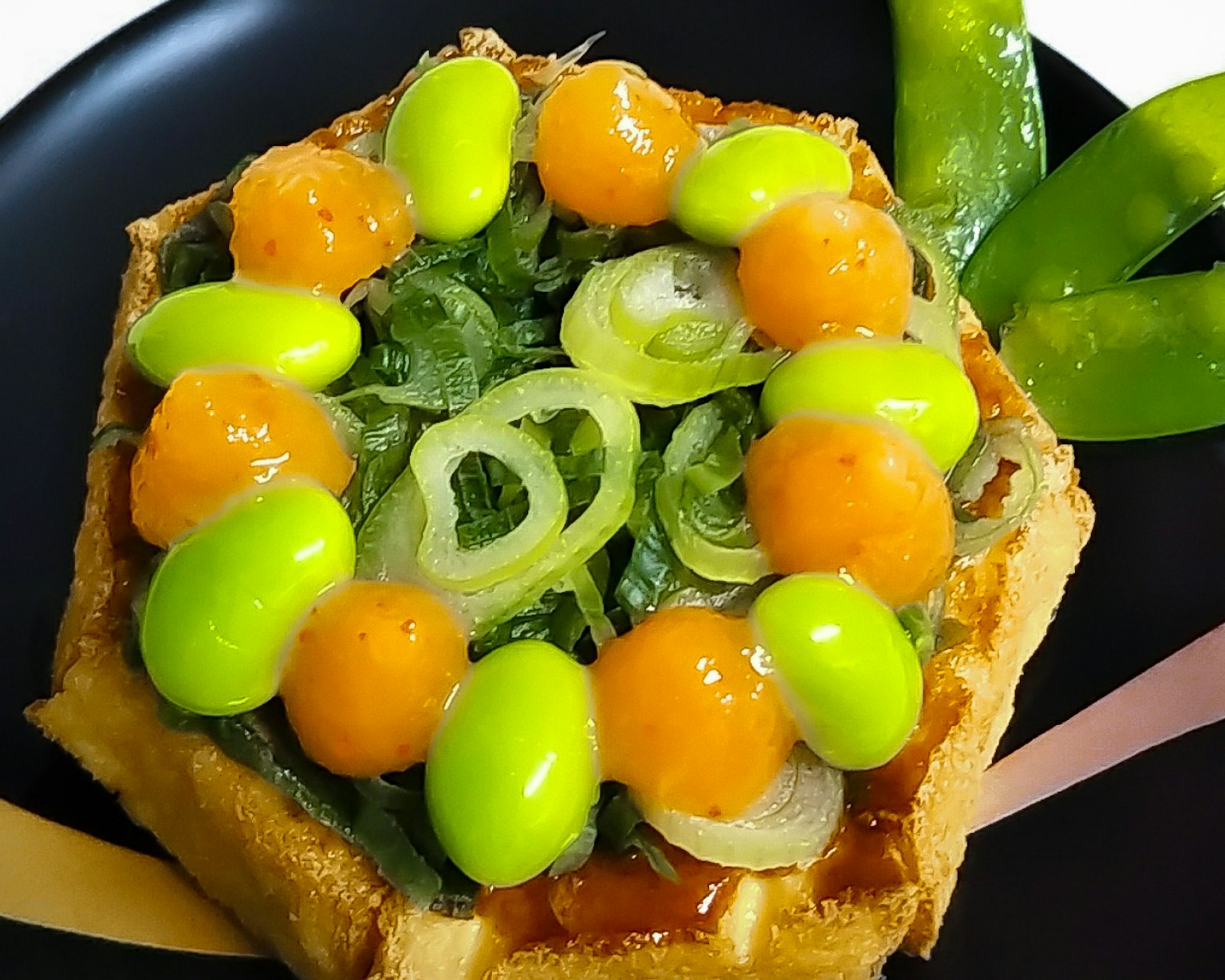 Colorful vegetable and fruit topped square open sandwich