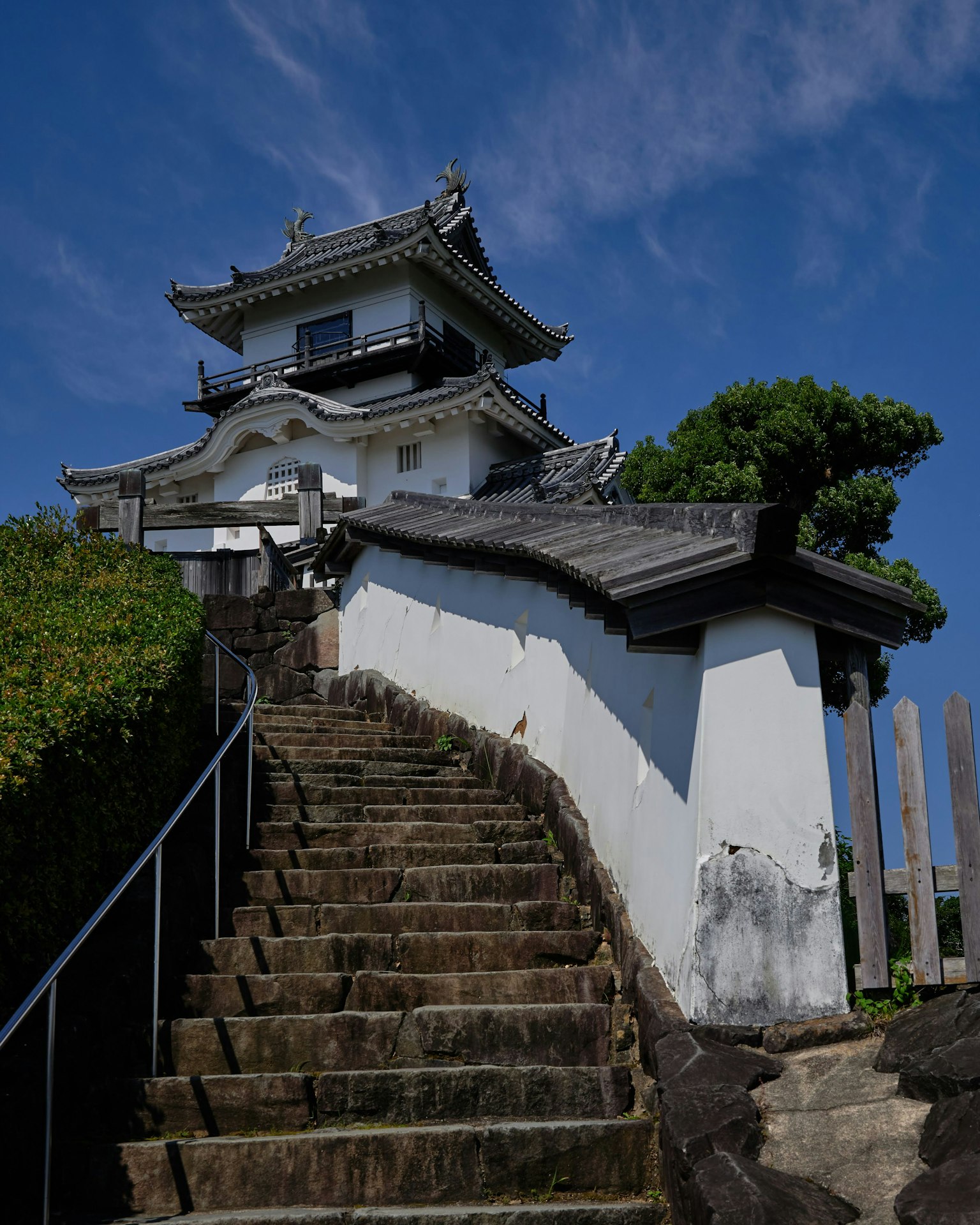 Traditional Japanese castle with stone steps and blue sky