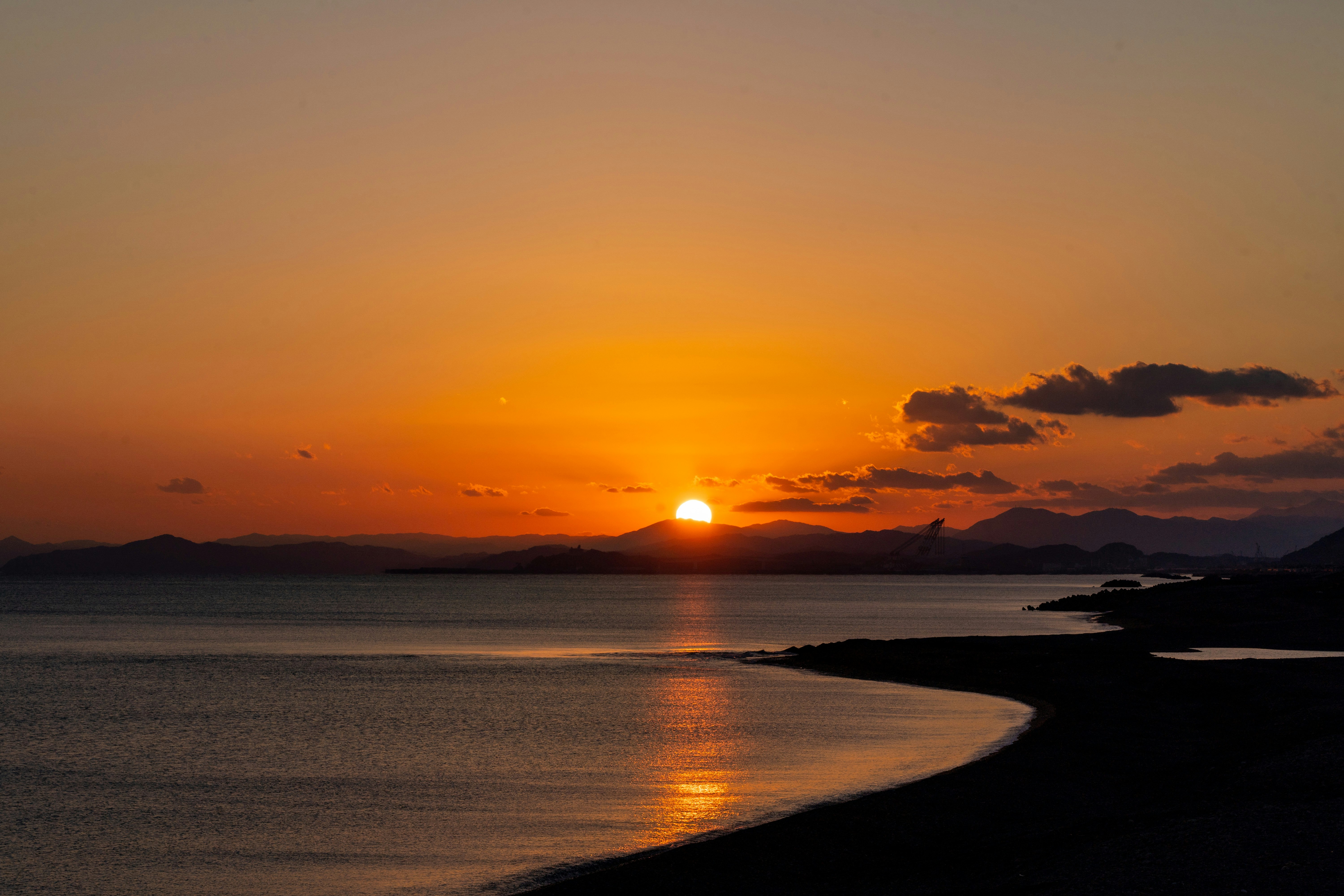 夕日に照らされる海と砂浜の風景
