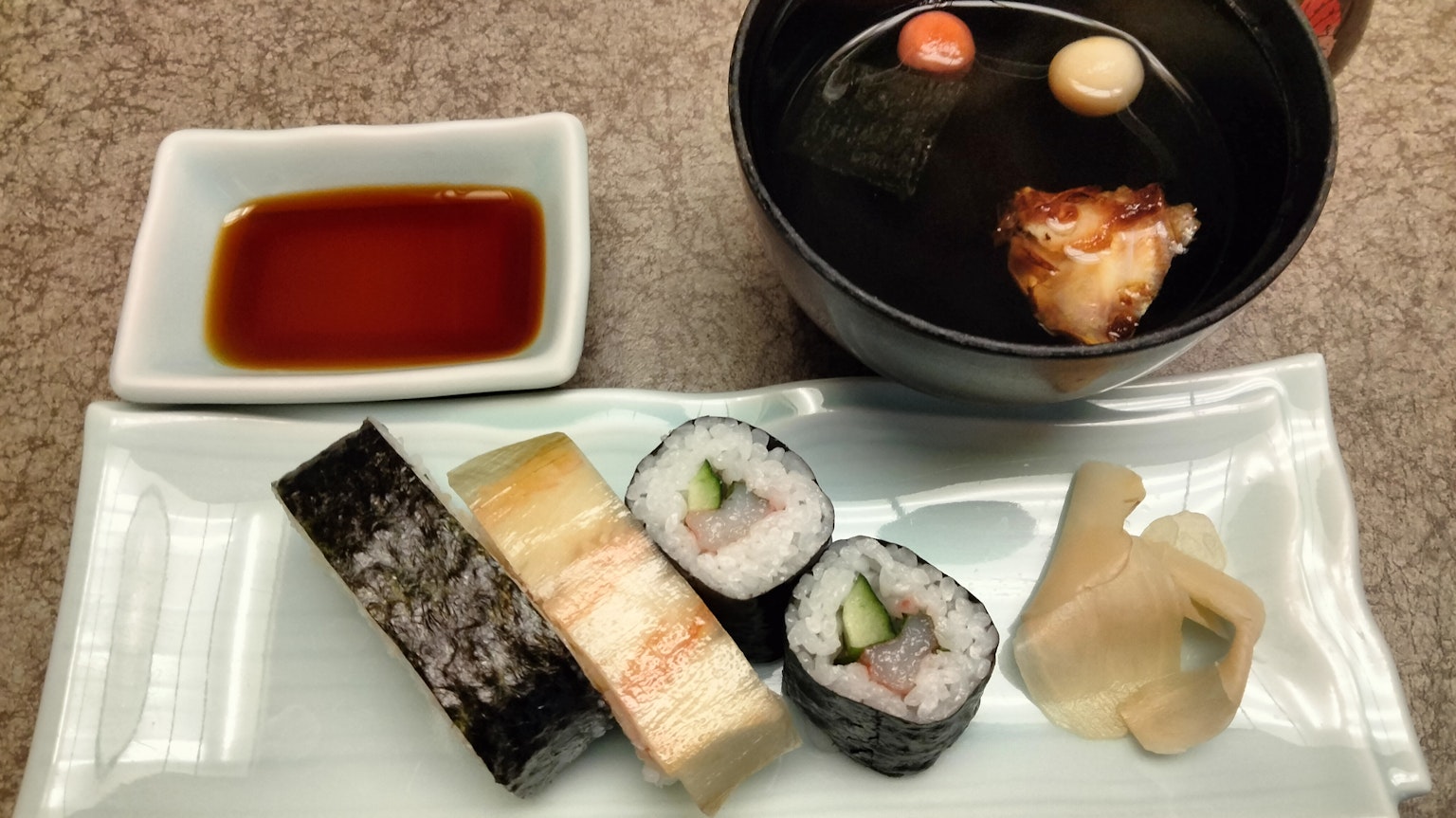 Sushi platter with miso soup soy sauce and pickled ginger