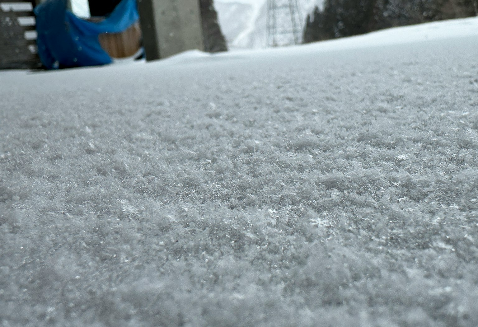 Snow-covered ground with a blurred background and texture