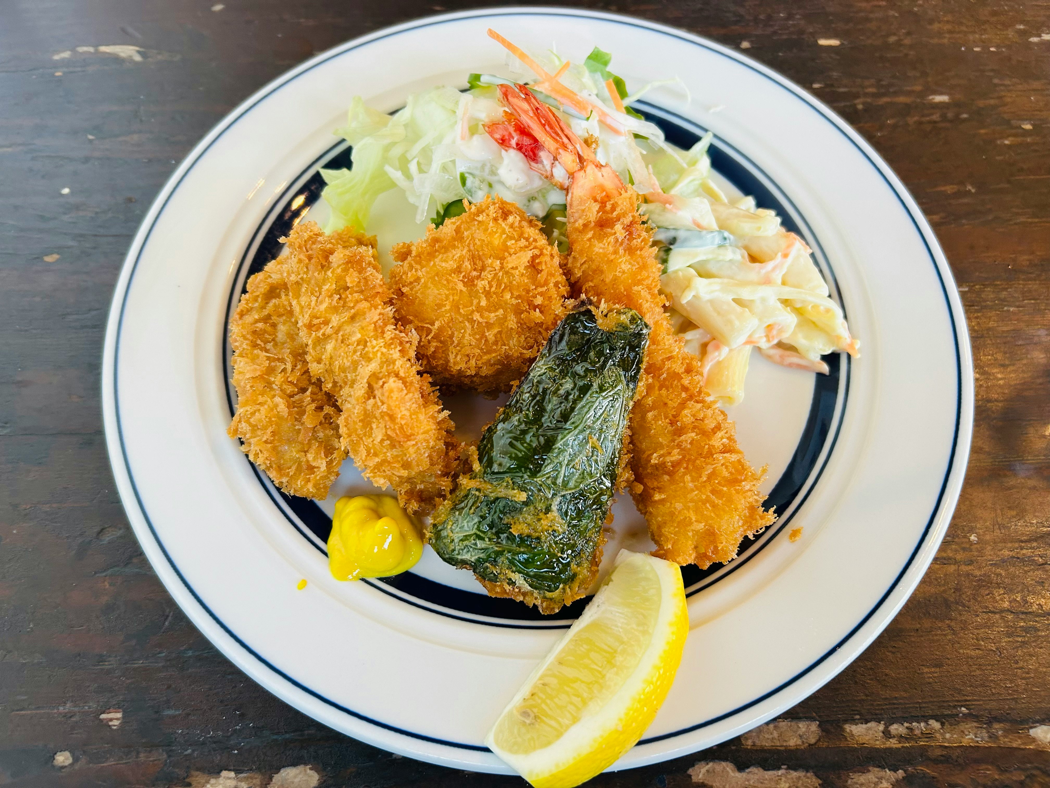 lemon-topped shrimp croquettes with salad on a plate