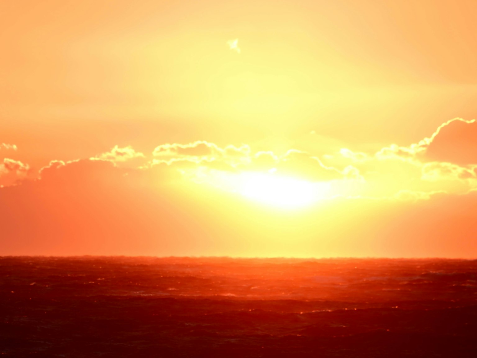 Orange sunset over the ocean horizon
