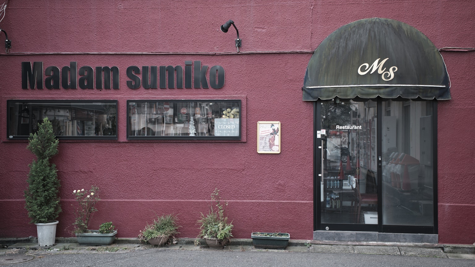 Madam sumiko 餐厅的外观 红色墙壁和盆栽植物
