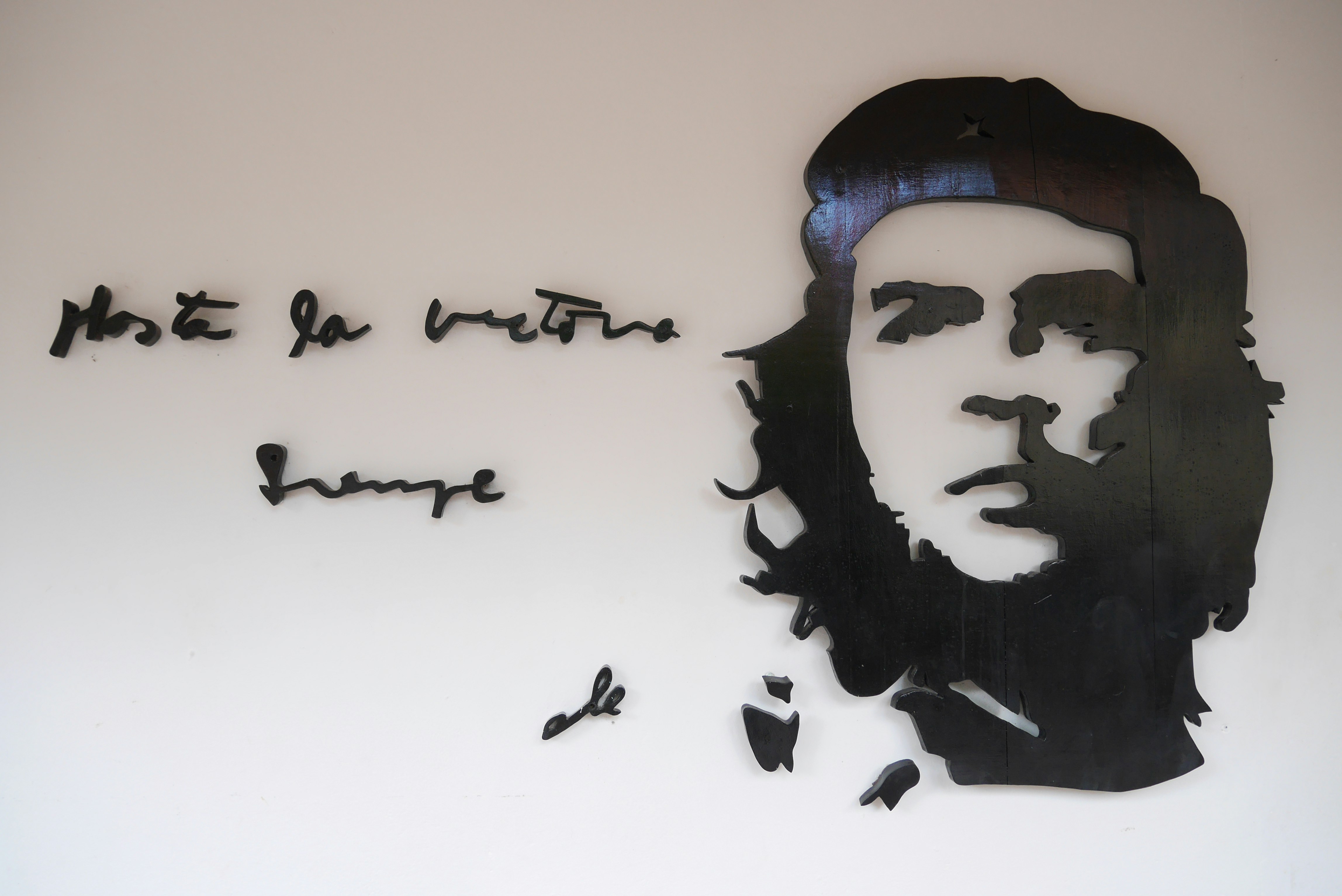 portrait illustration and handwritten text on a white wall