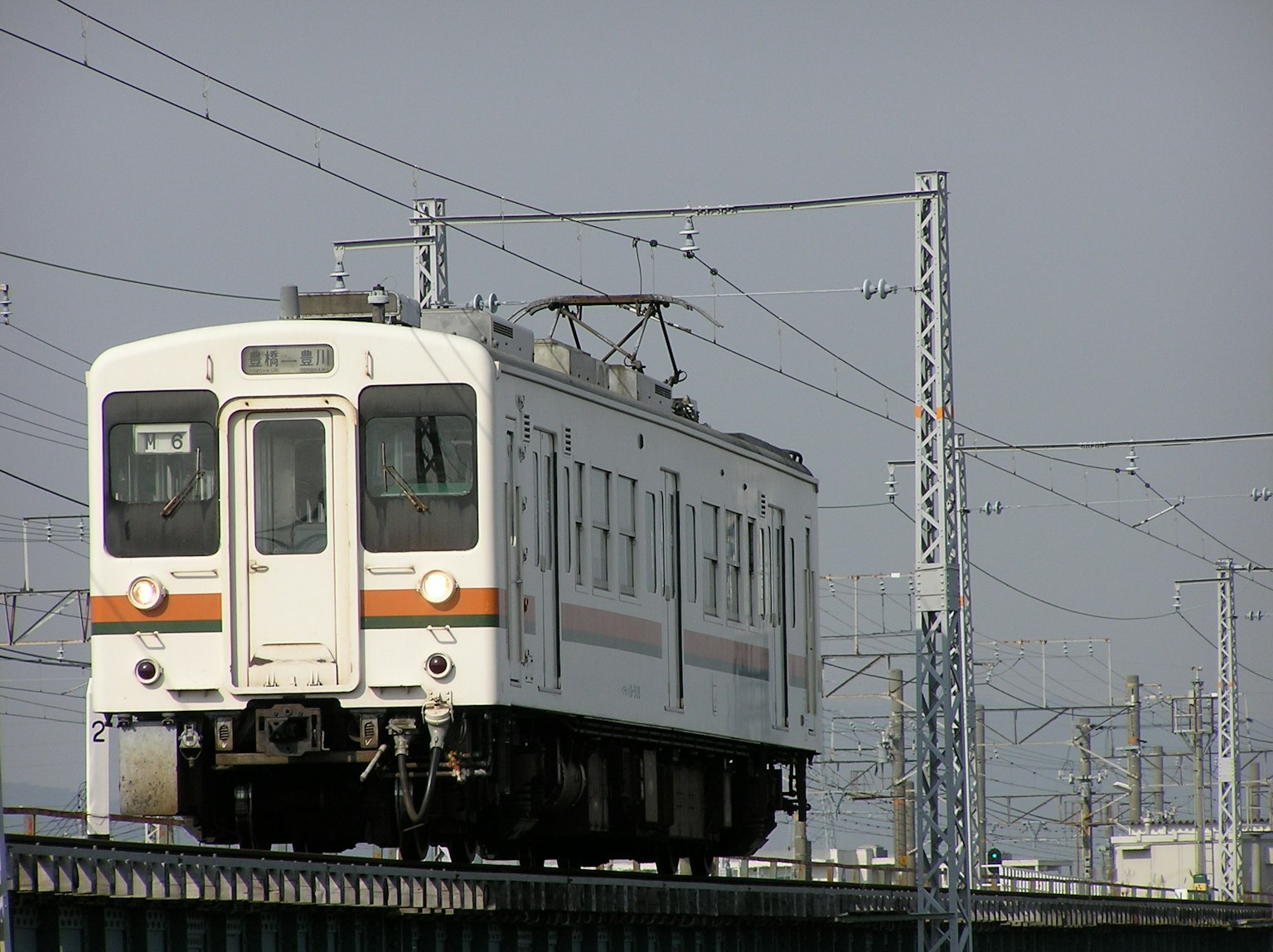 A white train running on an elevated track