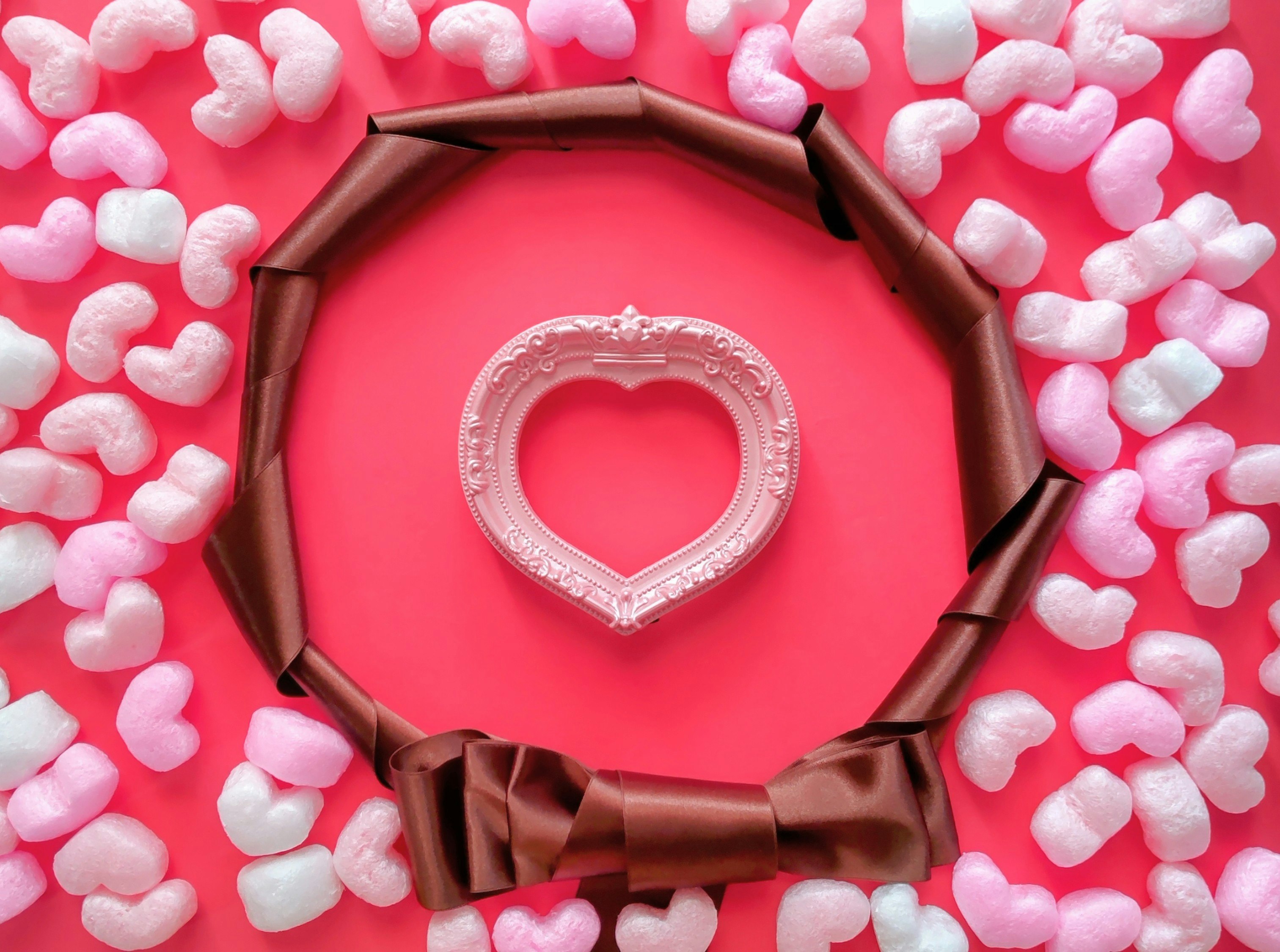 Valentine-style gift image with a pink heart ring and ribbon