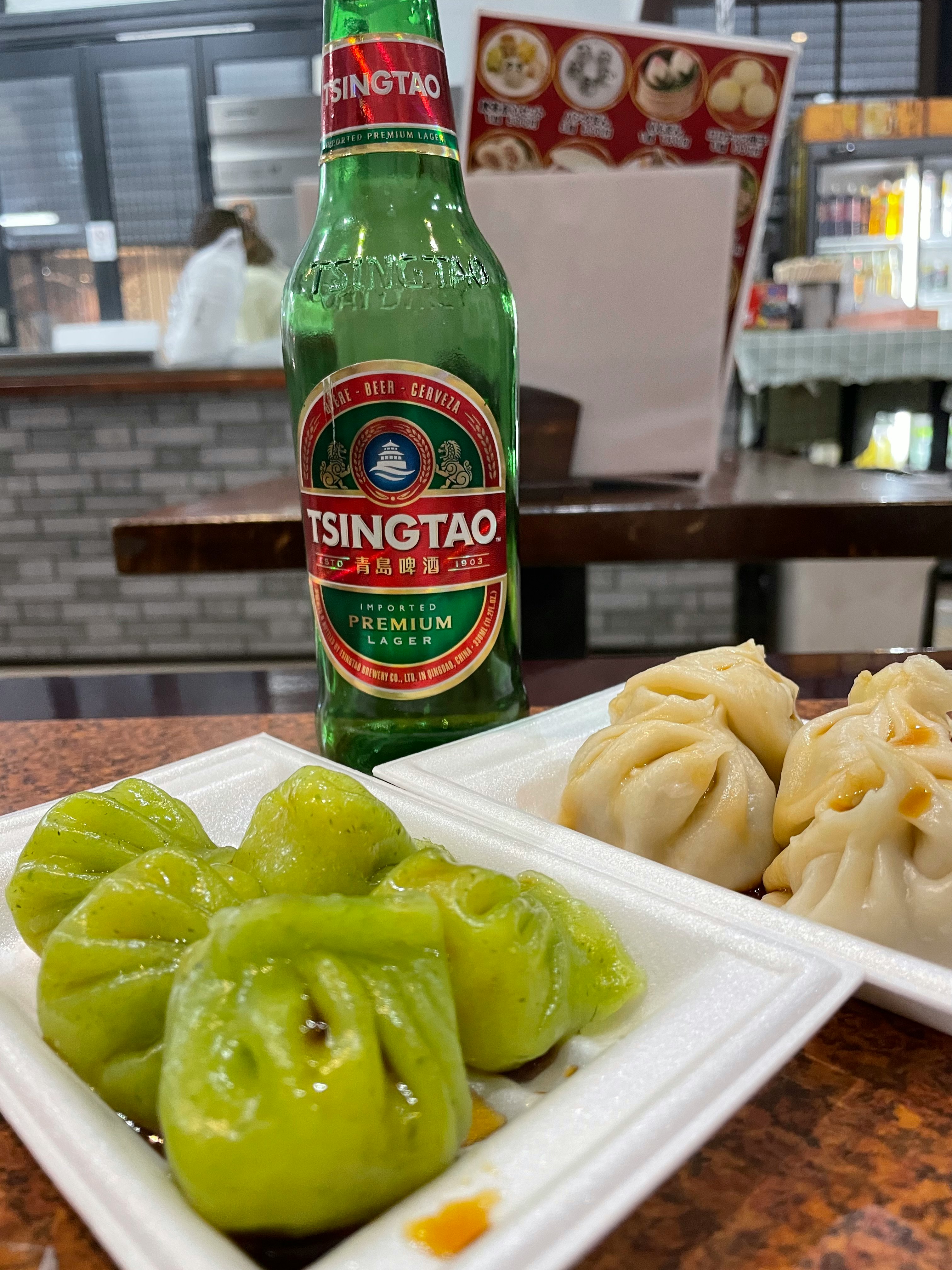 beer bottle and dumplings on a restaurant counter