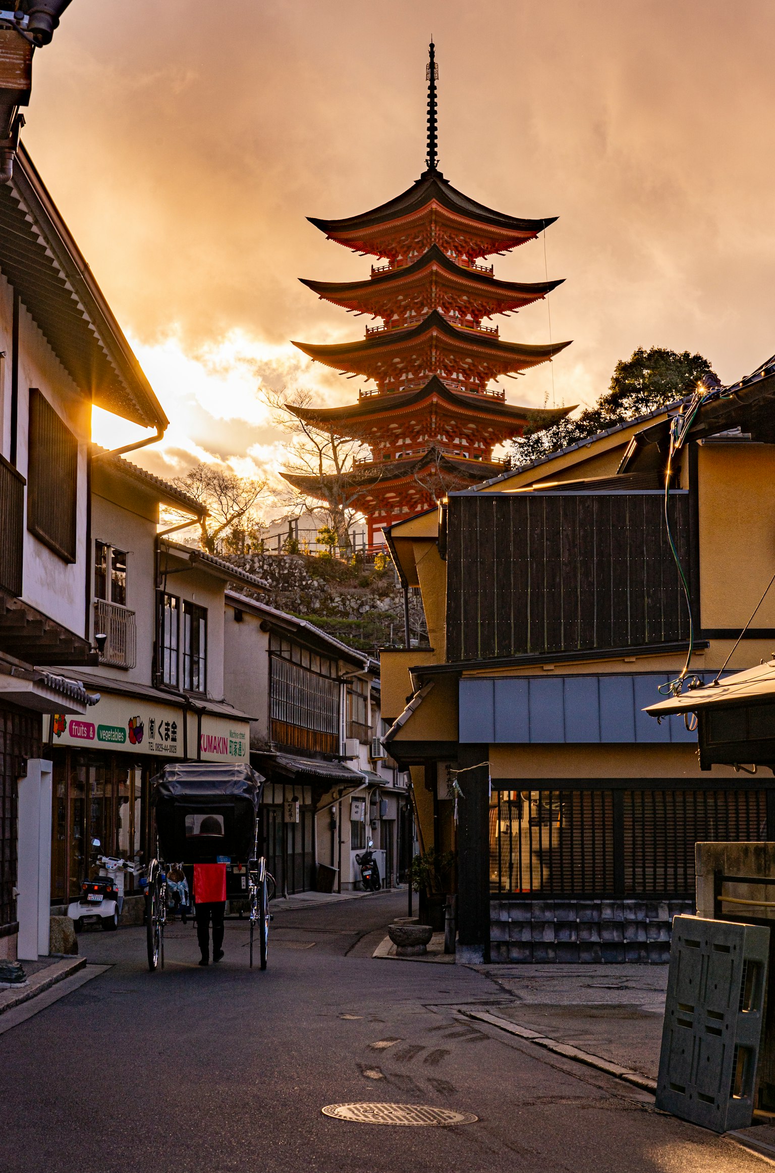 Five-story pagoda illuminated by sunset with traditional streets