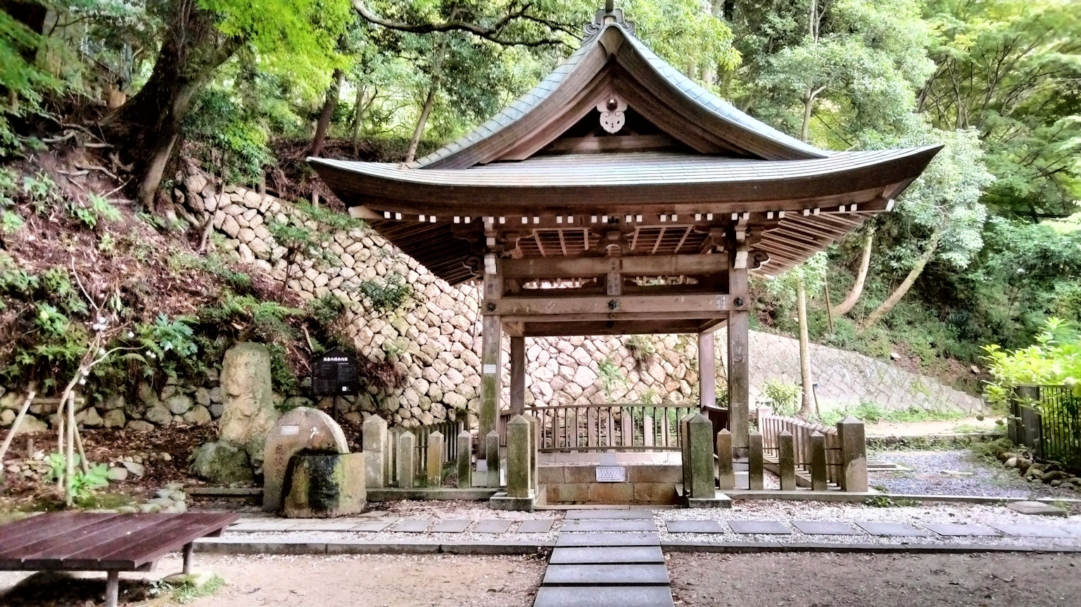 Wooden shrine building surrounded by lush greenery
