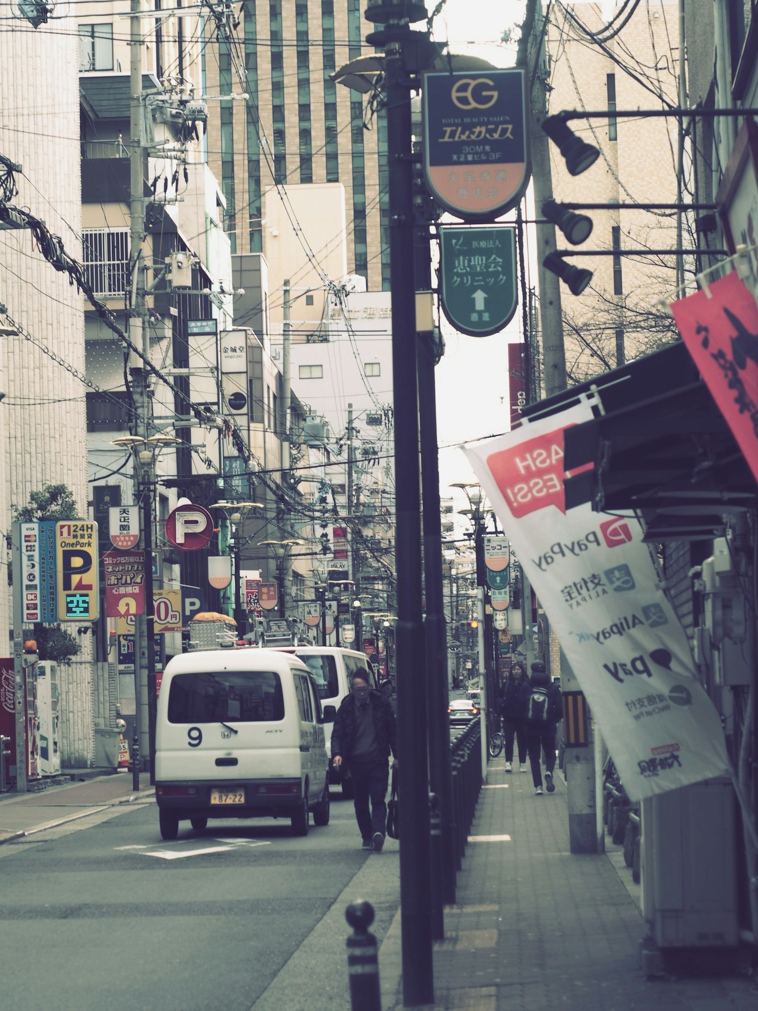 ภาพถนนในสภาพแวดล้อมเมืองที่มีรถและคนเดิน