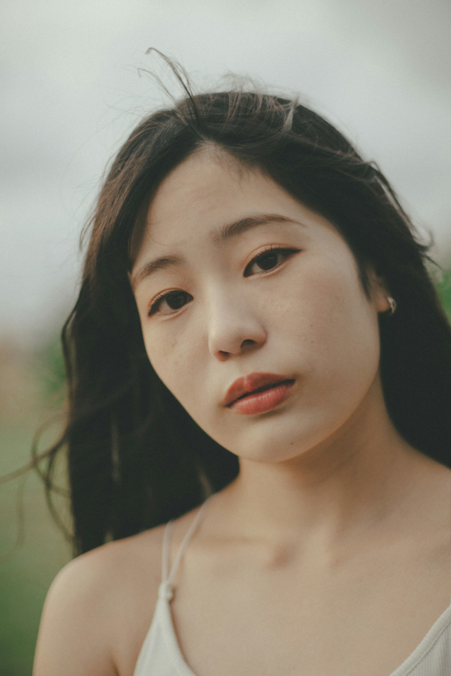 Potret wanita dengan rambut mengalir di latar belakang alami