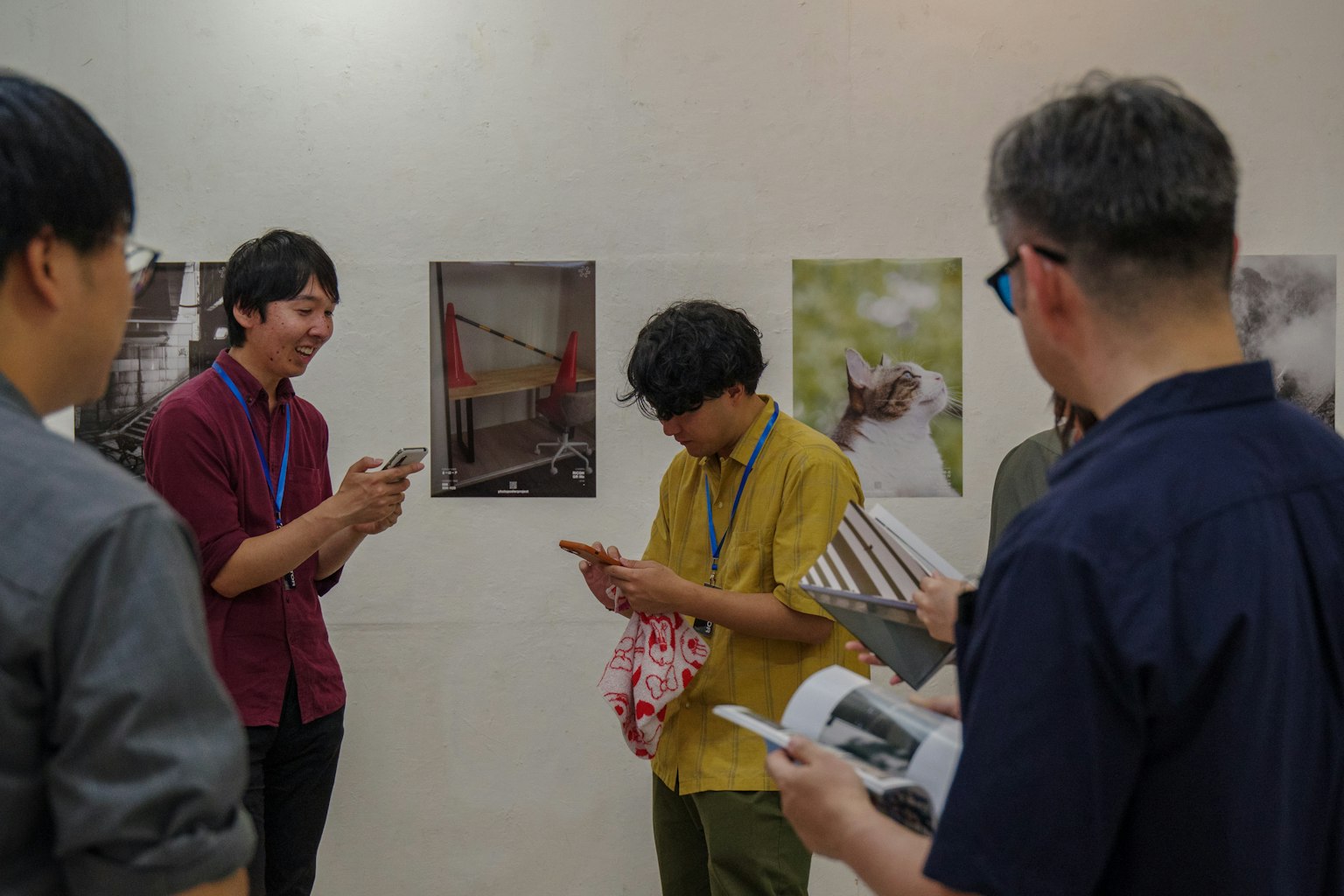 Group of young people viewing photographs at an exhibition