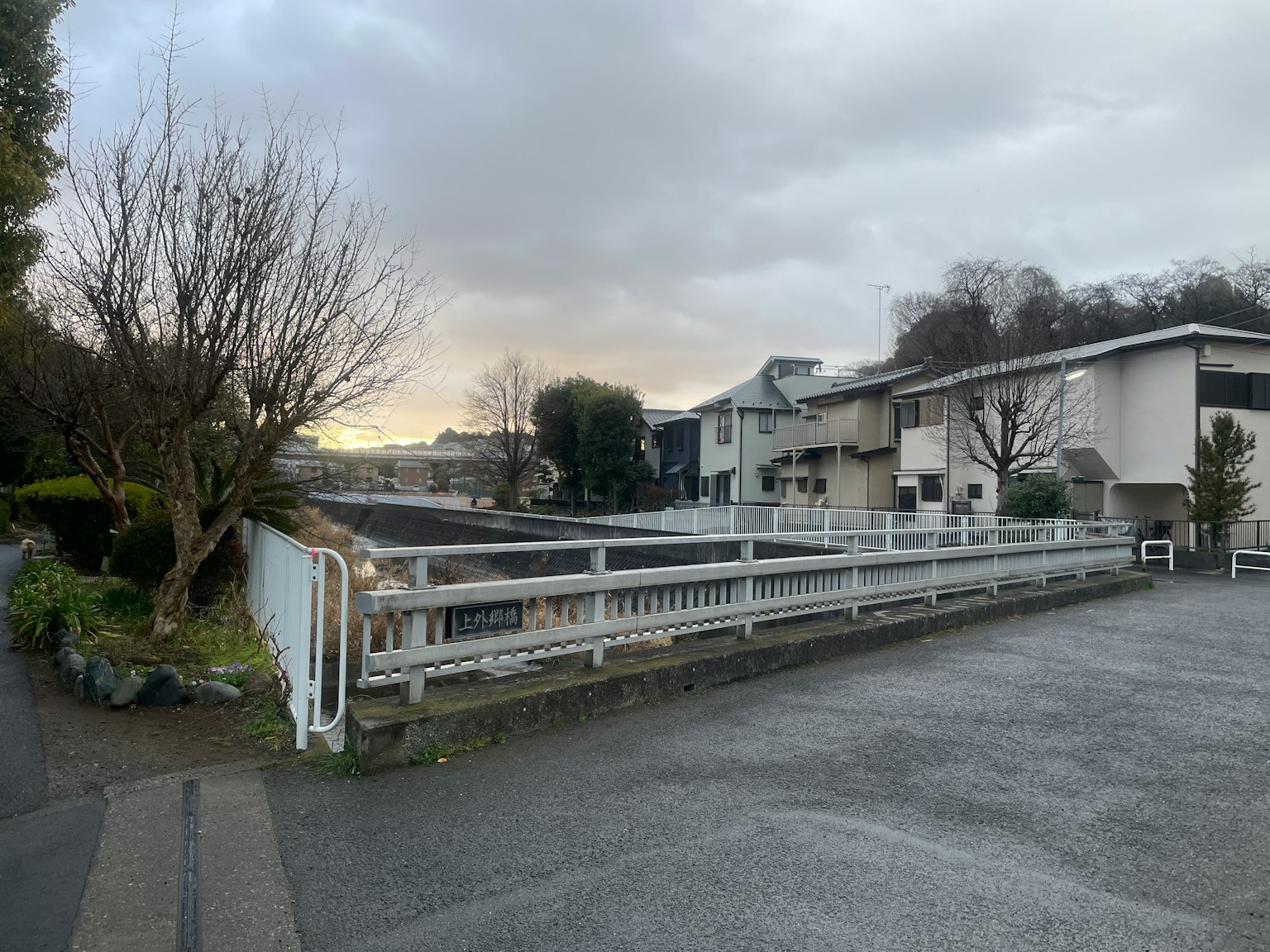 Quiet residential street view with cloudy sky
