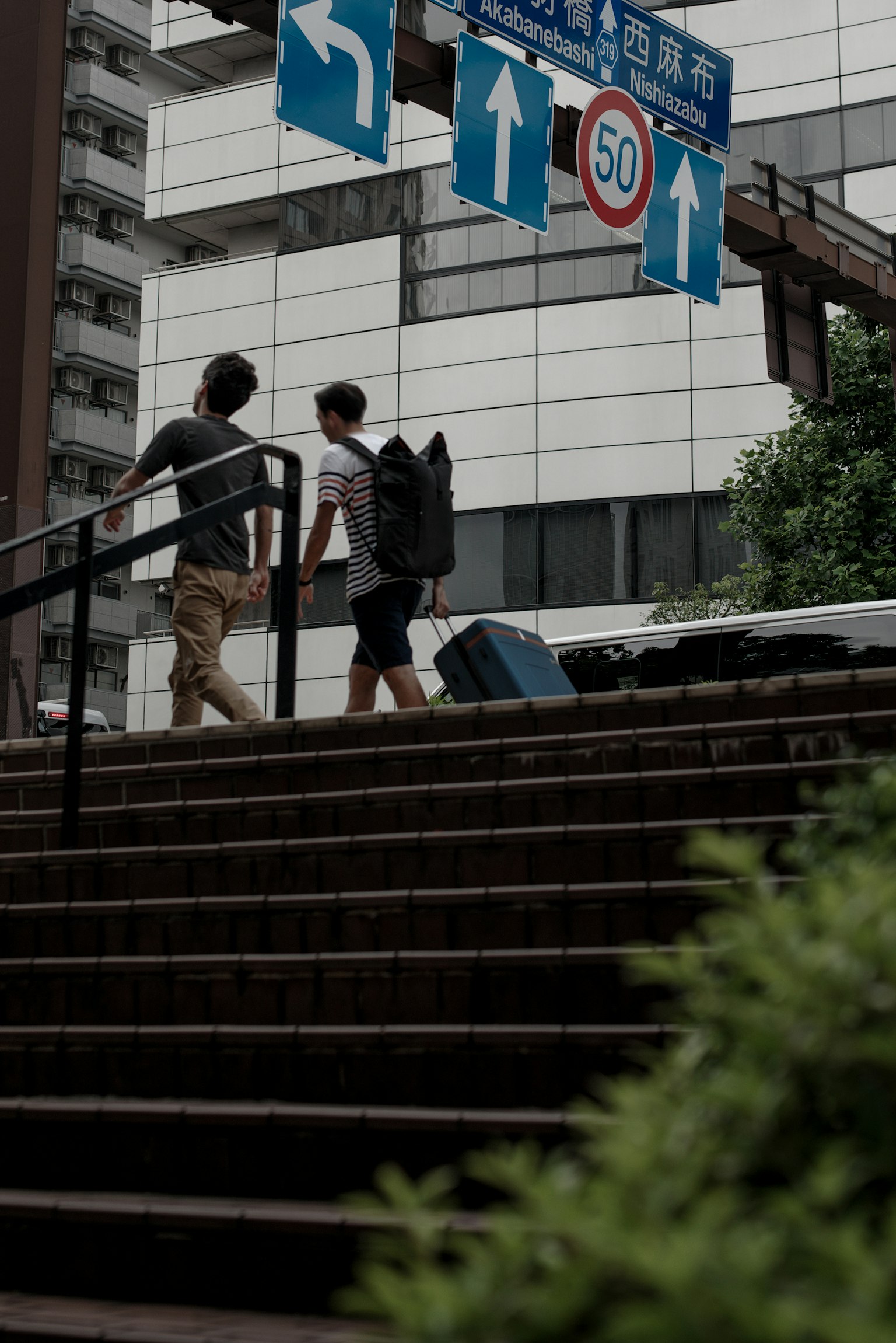Two men walking up stairs in an urban setting