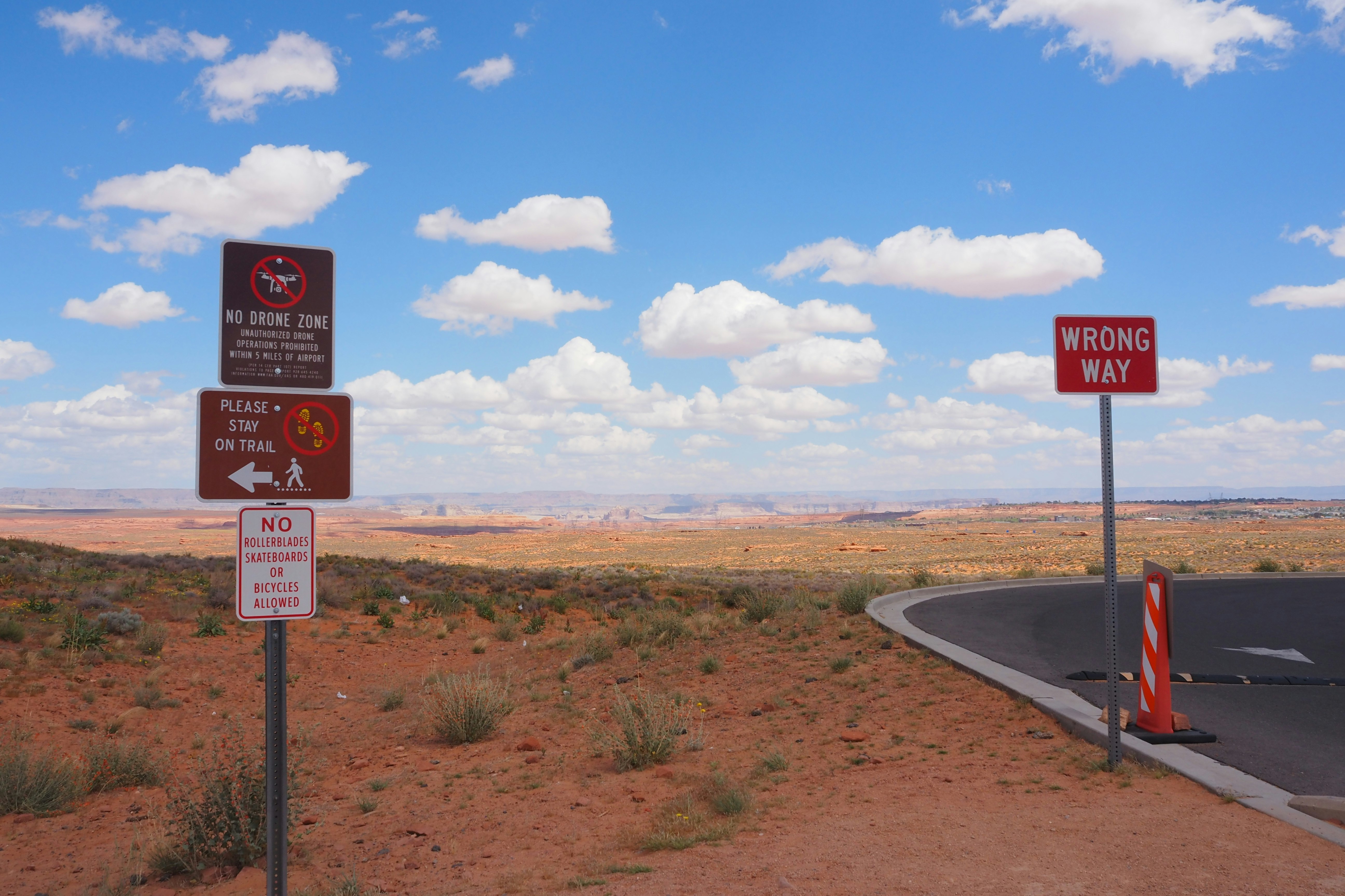 winding road with warning signs in a desert landscape