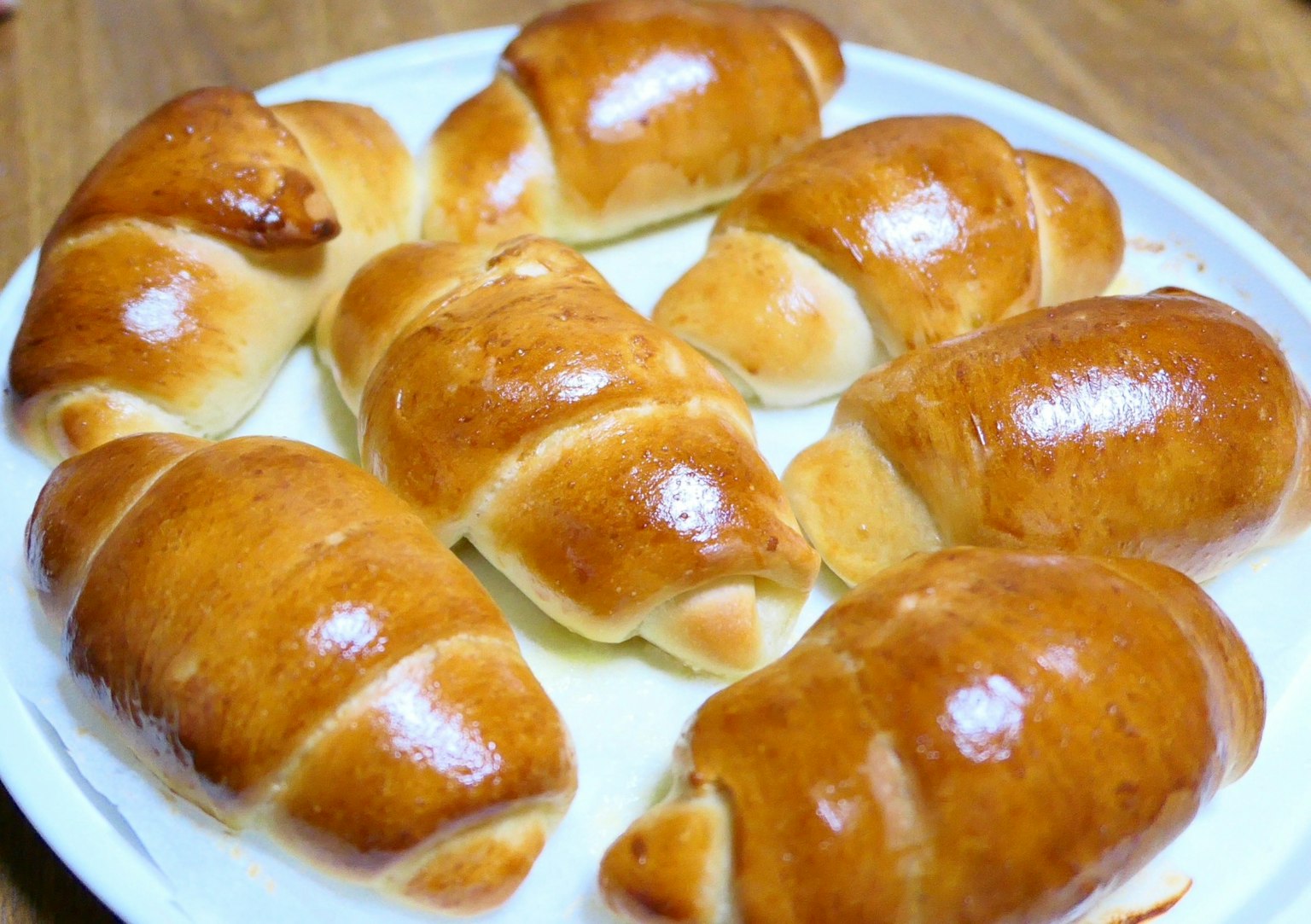 Freshly baked croissants arranged on a plate