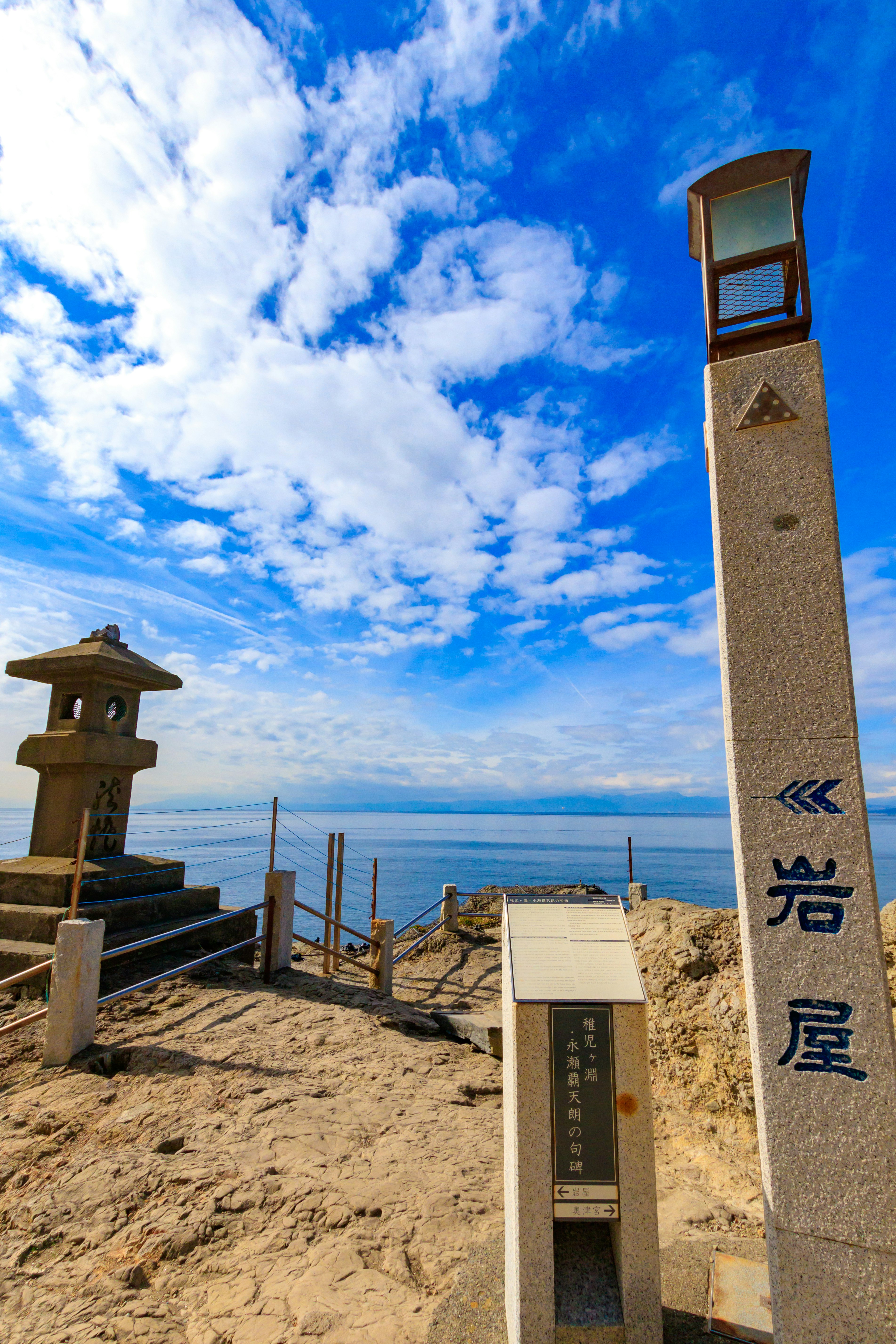 Scenic view of Iwaya lantern and stone monument against the sea