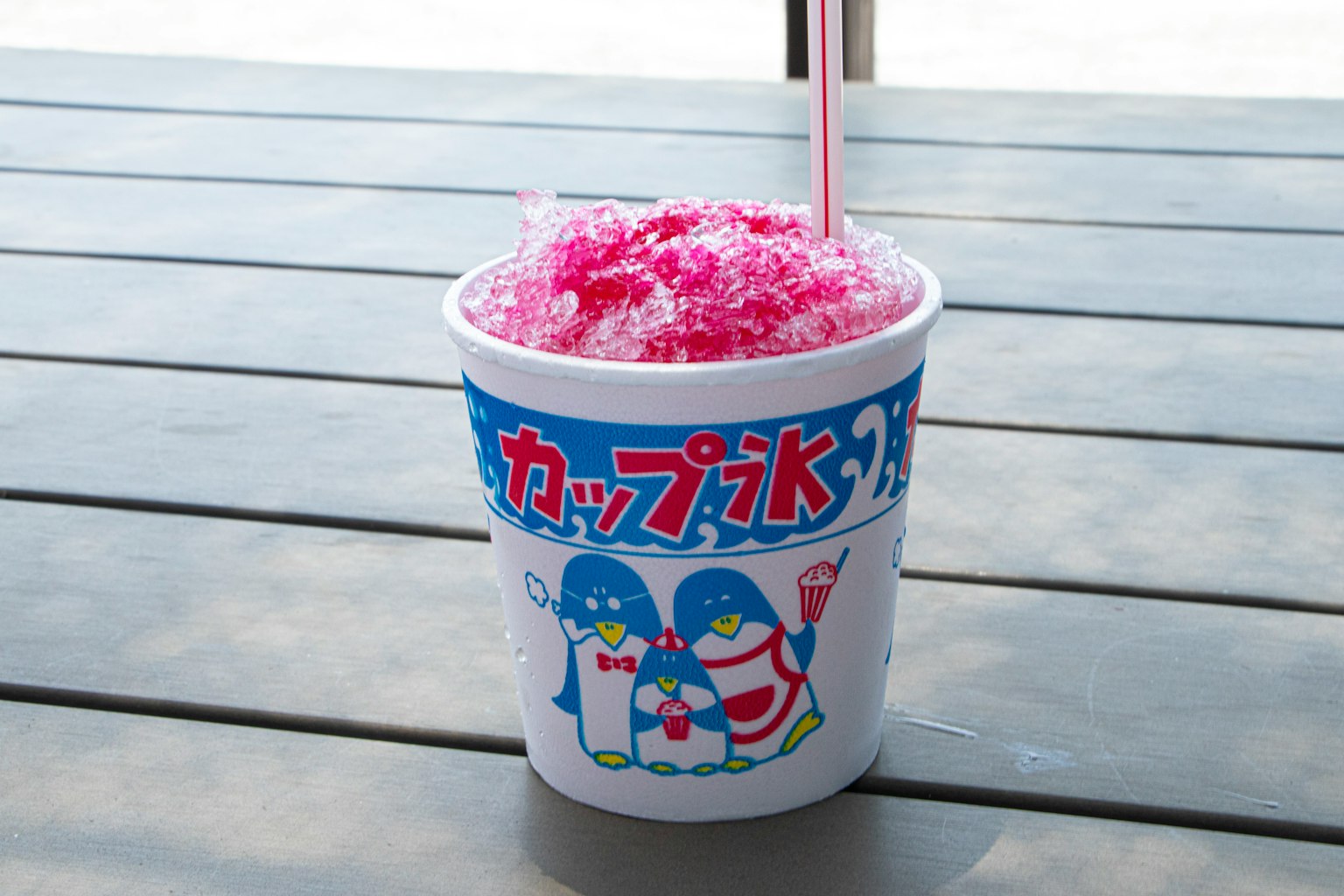 A cup filled with pink shaved ice