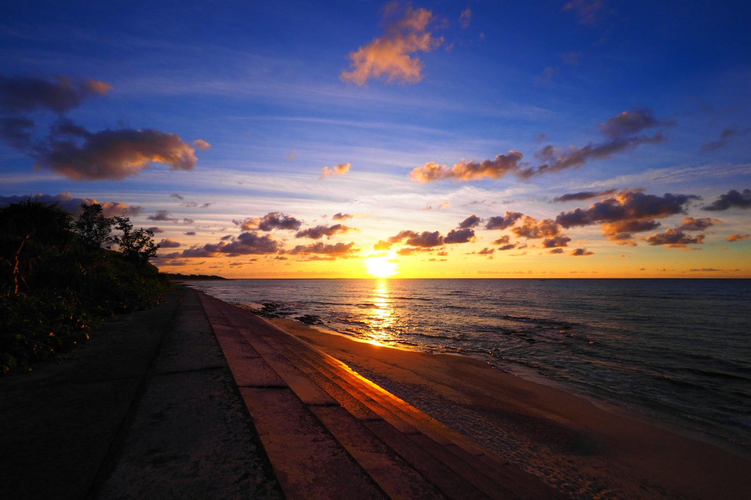 Coastal sunset view with blue sky and orange sunlight