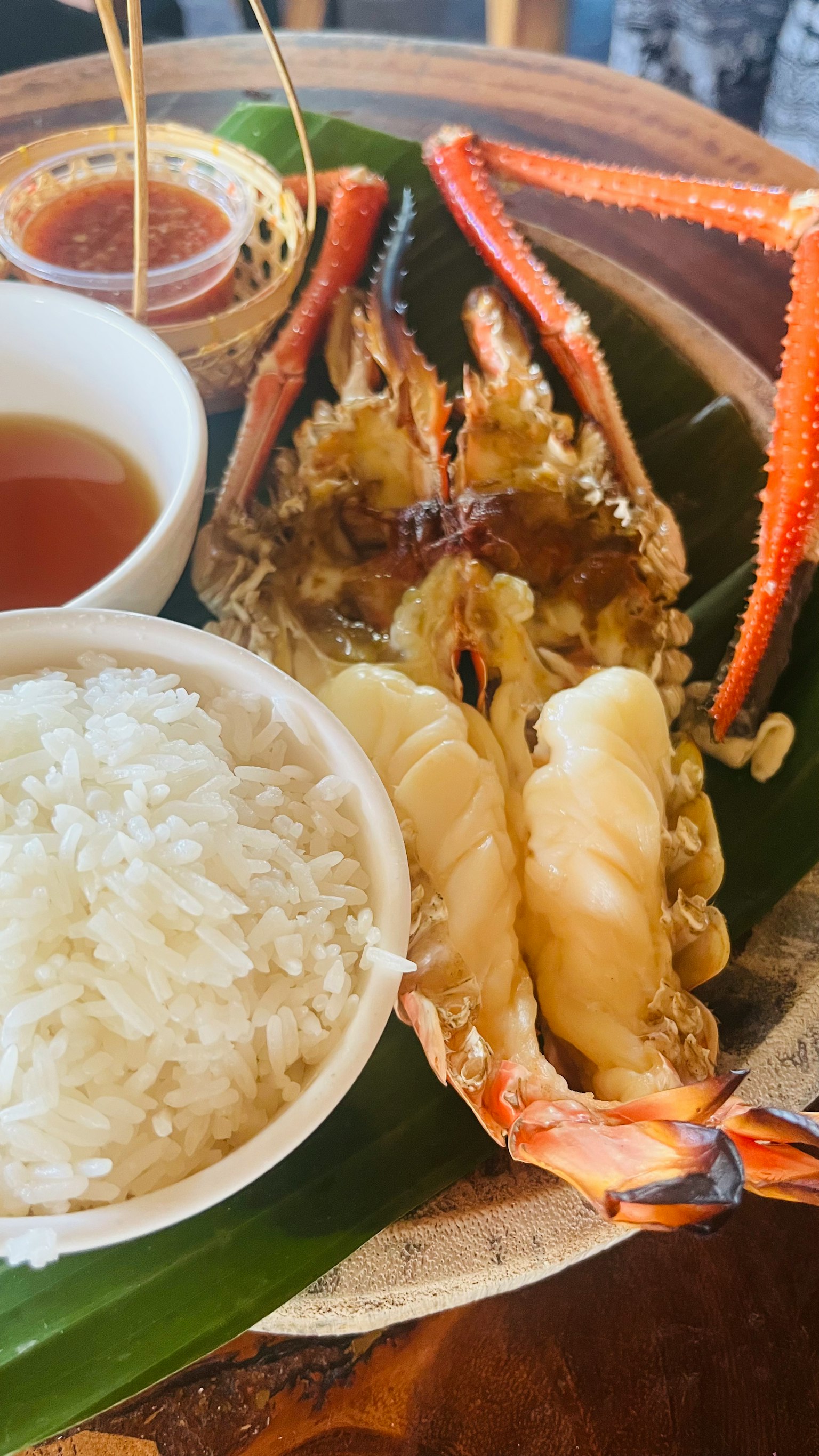 A large crab dish served with rice on a leaf