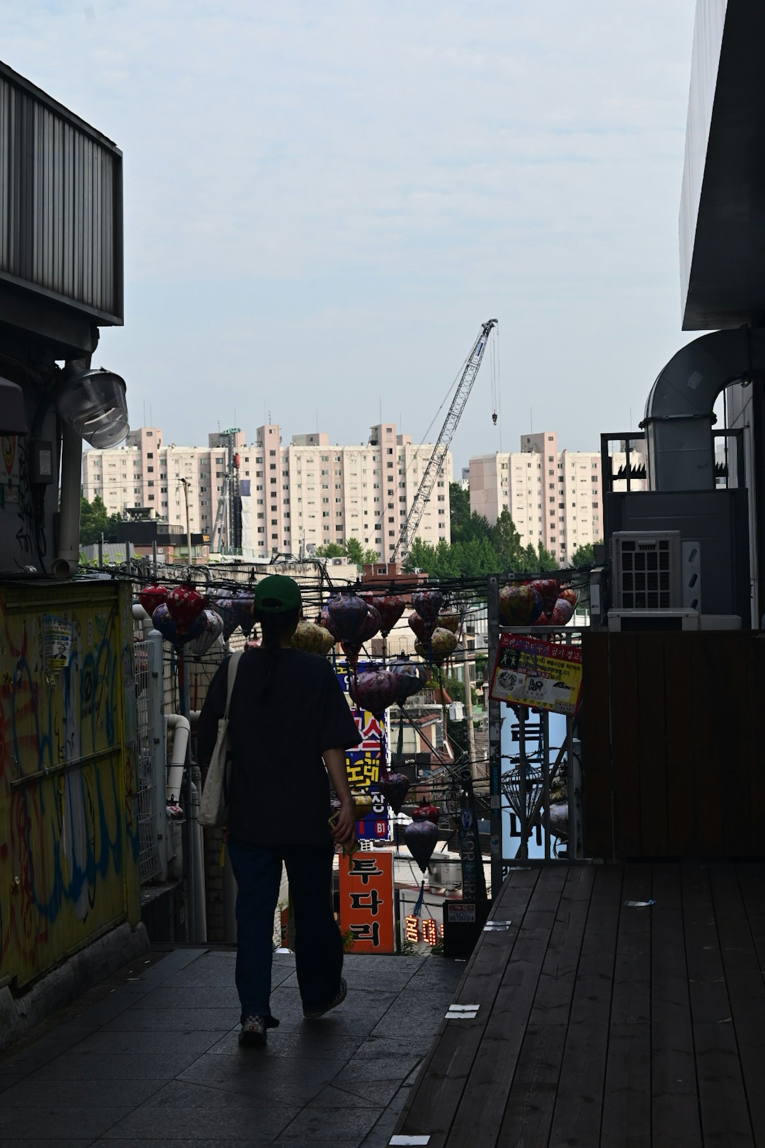 A person walking in an urban setting with high-rise buildings in the background
