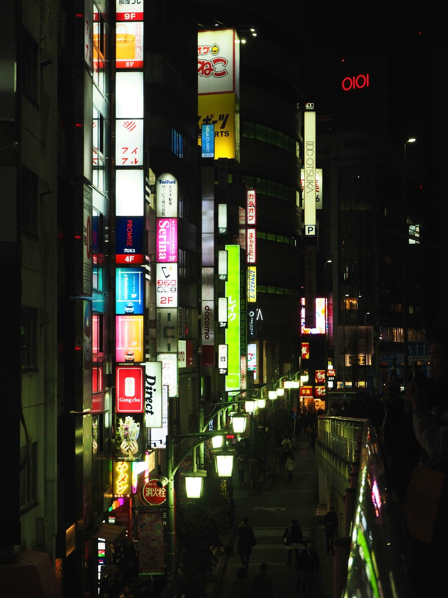 nighttime neon-lined narrow shopping alley