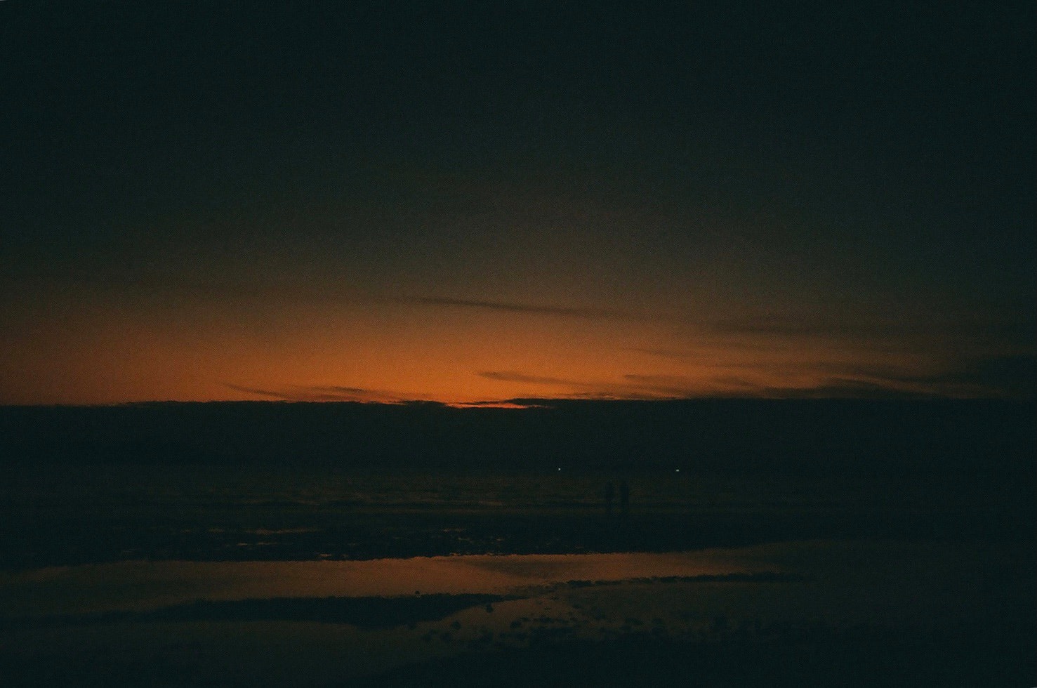 dawn sky with a glowing horizon and layered clouds