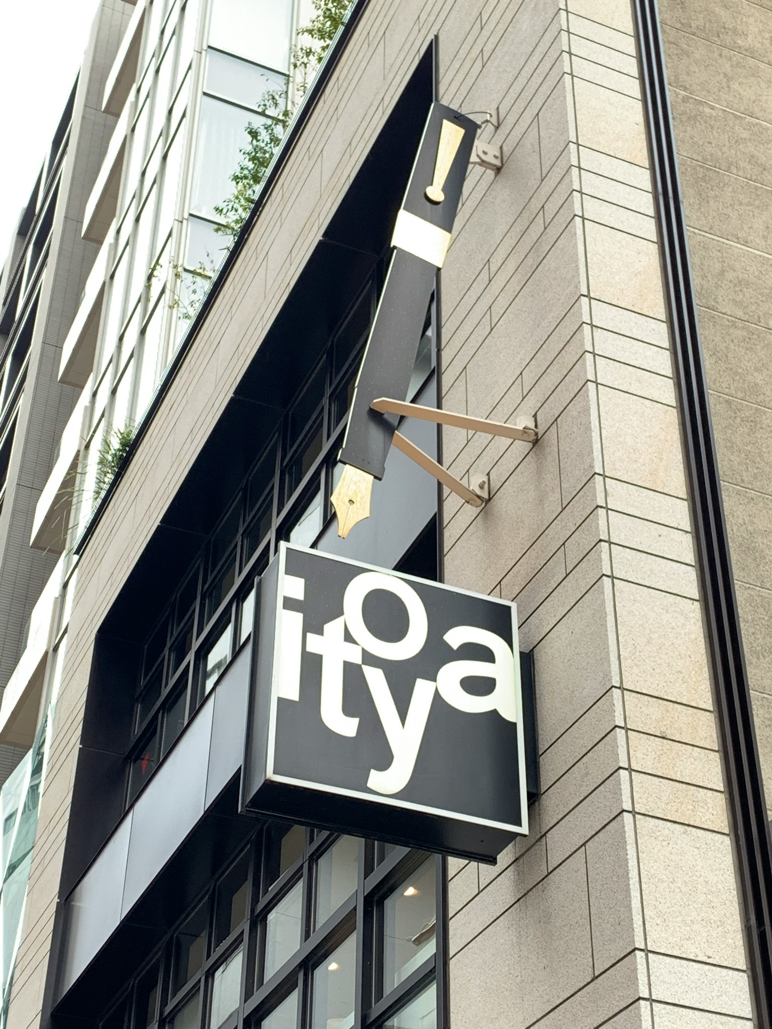 Unique sign design attached to a modern building featuring black and white colors