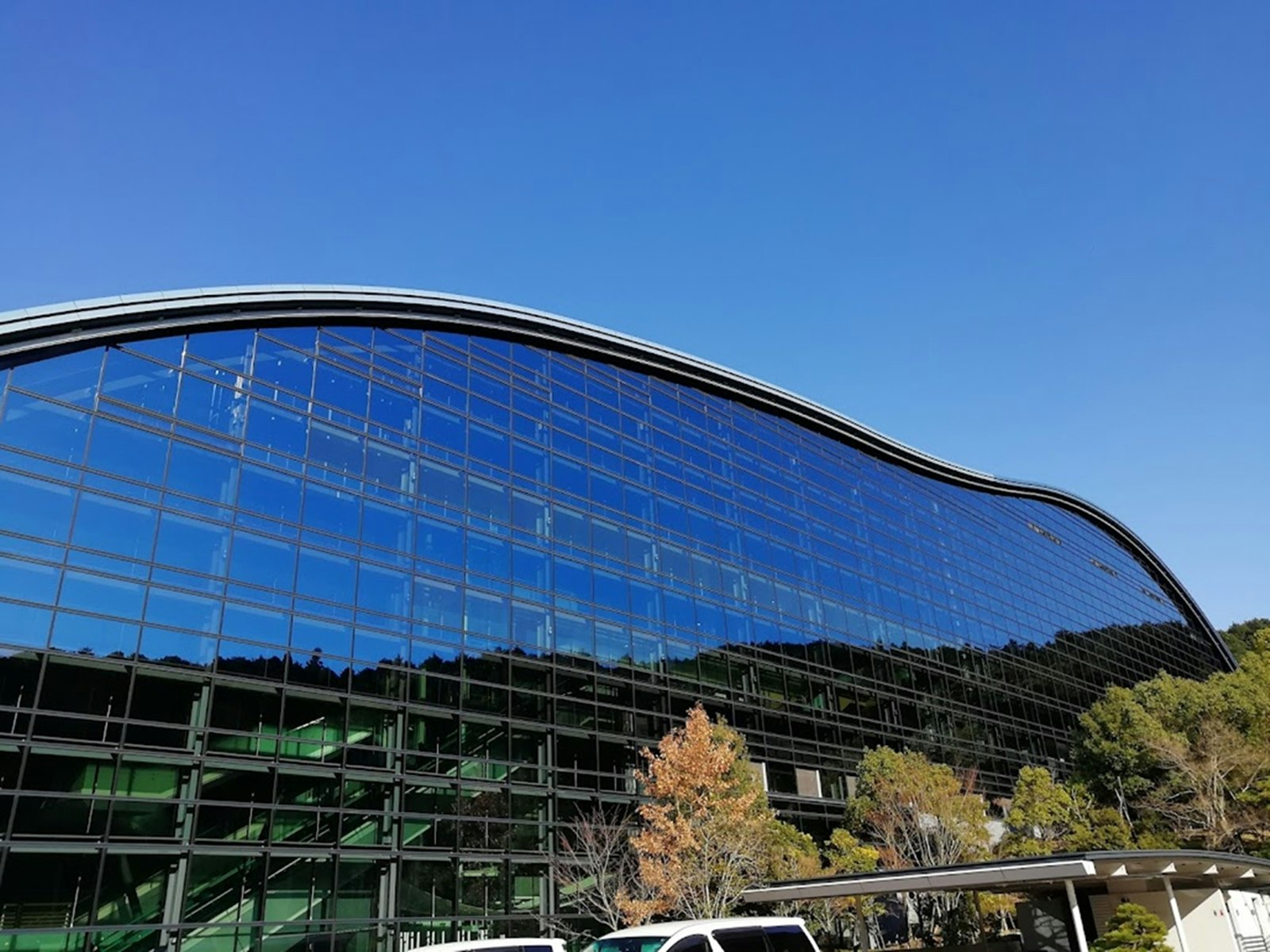 large glass building under a blue sky