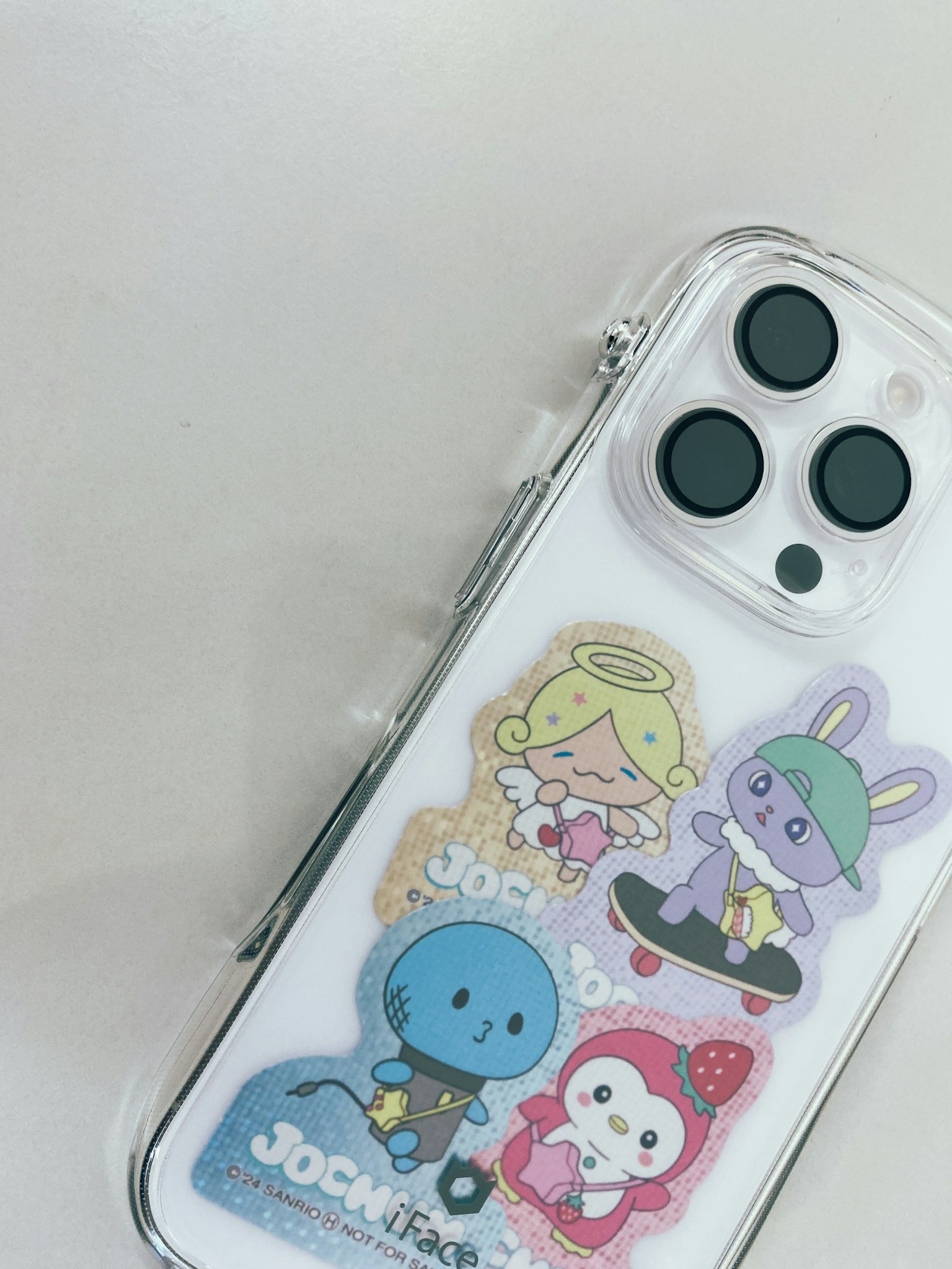 Clear smartphone case adorned with colorful character stickers