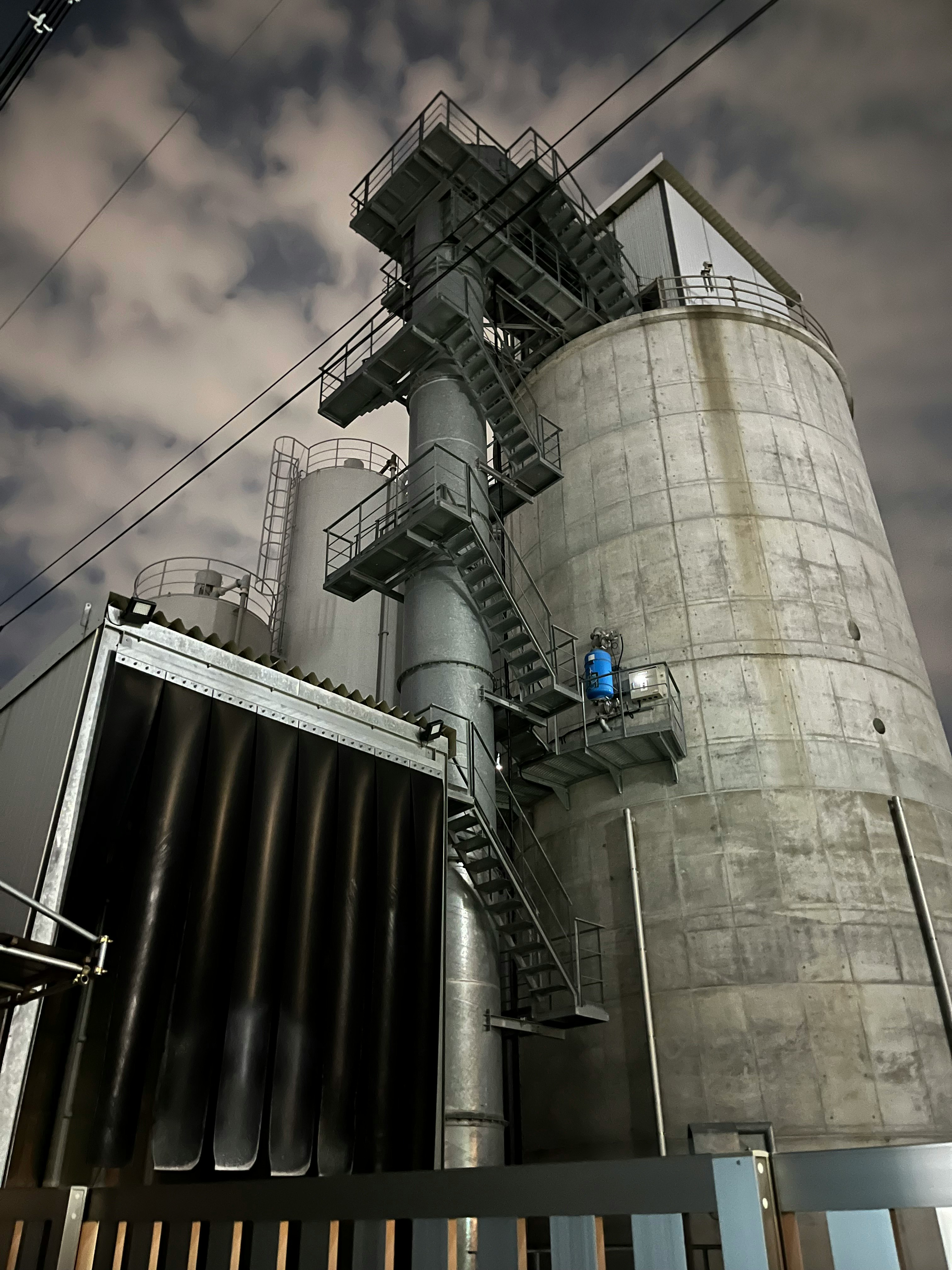 工業プラントの巨大な円筒タンクと配管設備