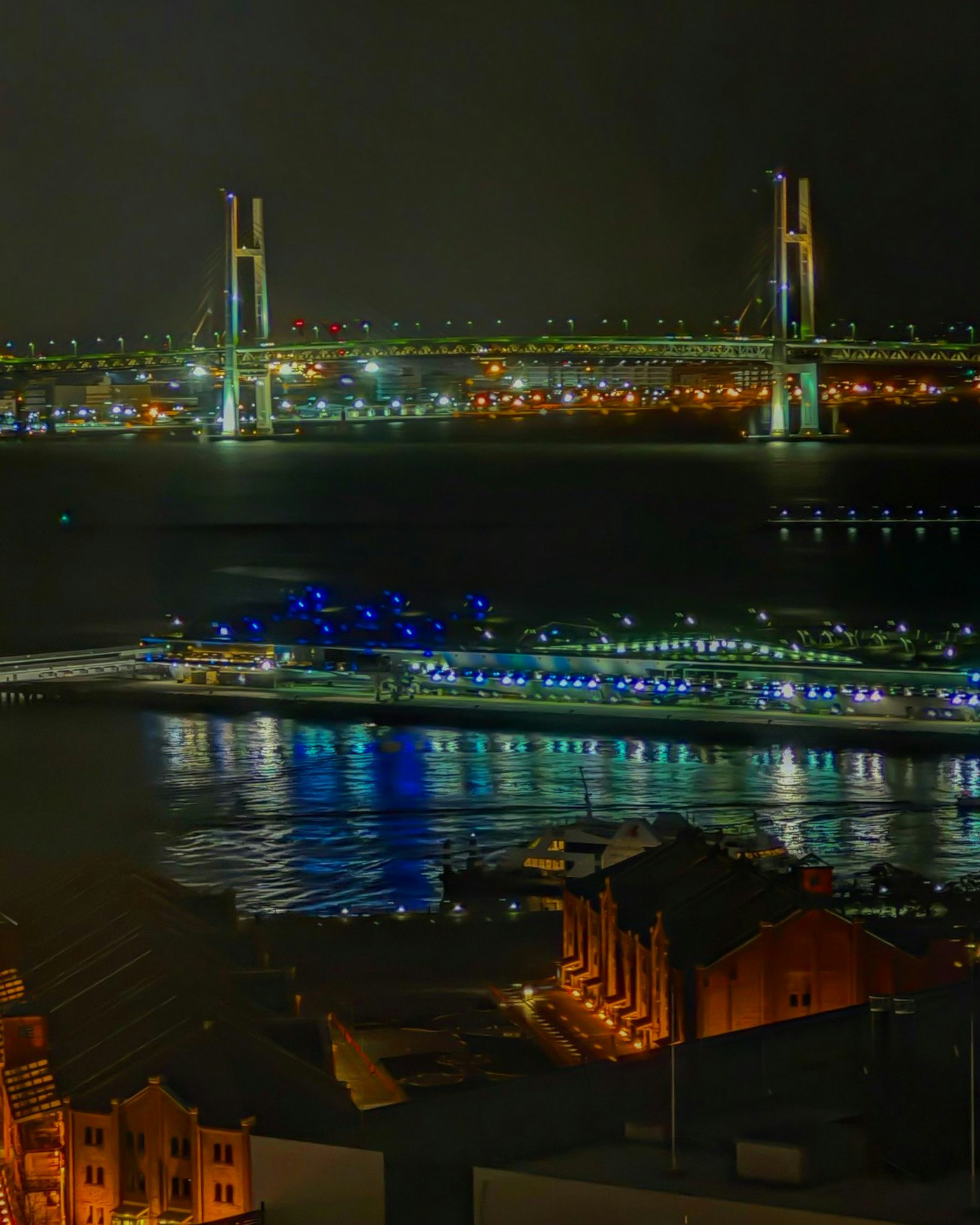 夜の横浜・みなとみらいの海沿いに広がるライトアップされた橋と港の眺め