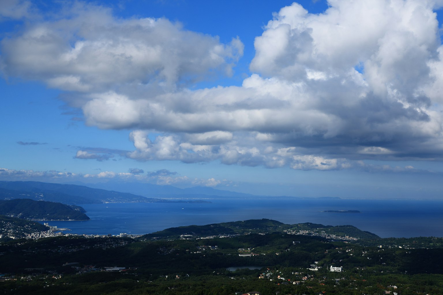 A panoramic view of blue sky and white clouds over the ocean