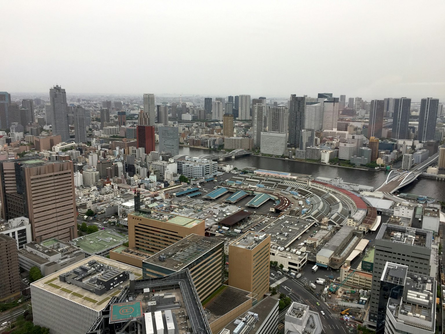 Aerial view of Tokyo skyline featuring high-rise buildings and a river